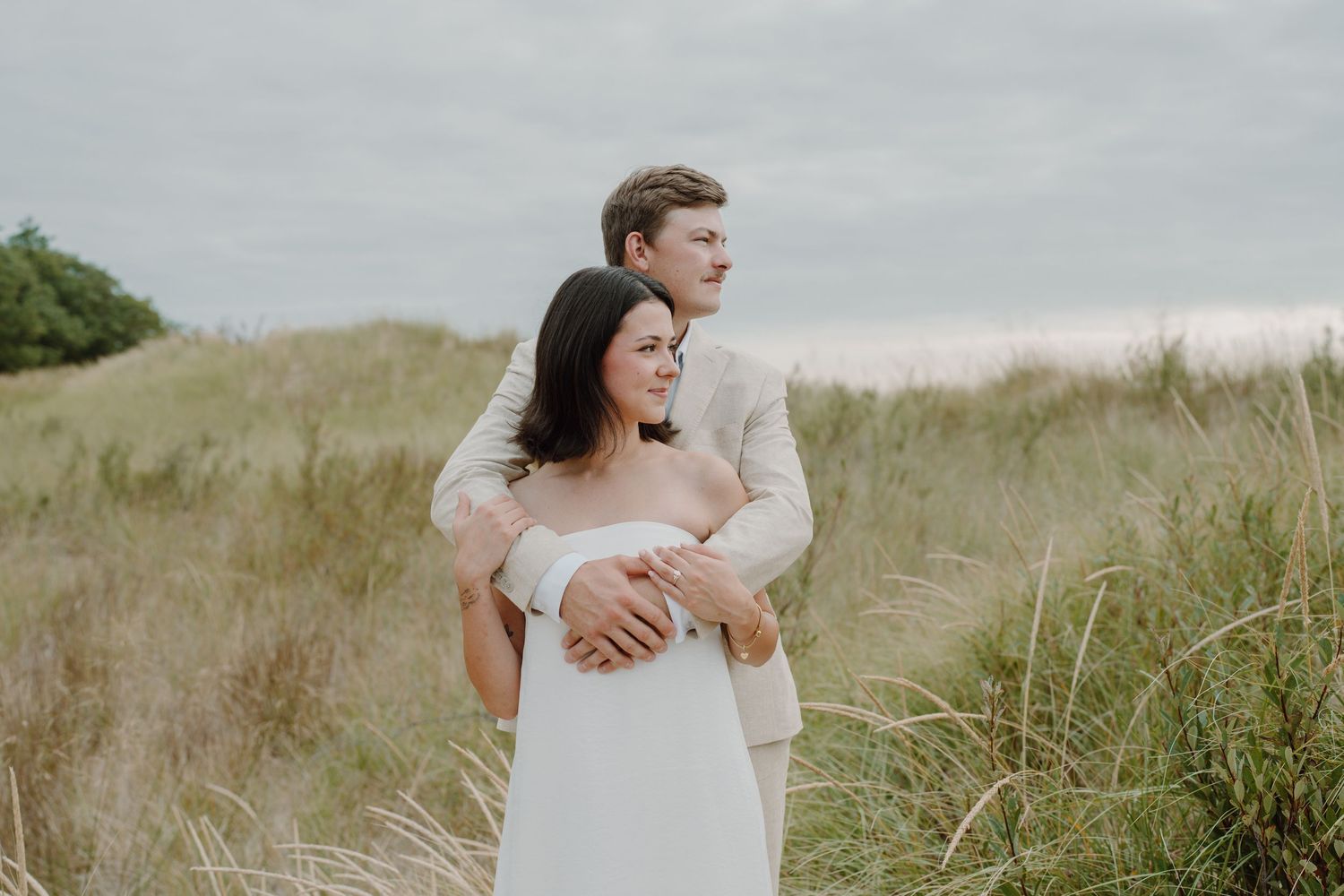Wedding photography sequence showing couple's natural interactions on beach dunes.