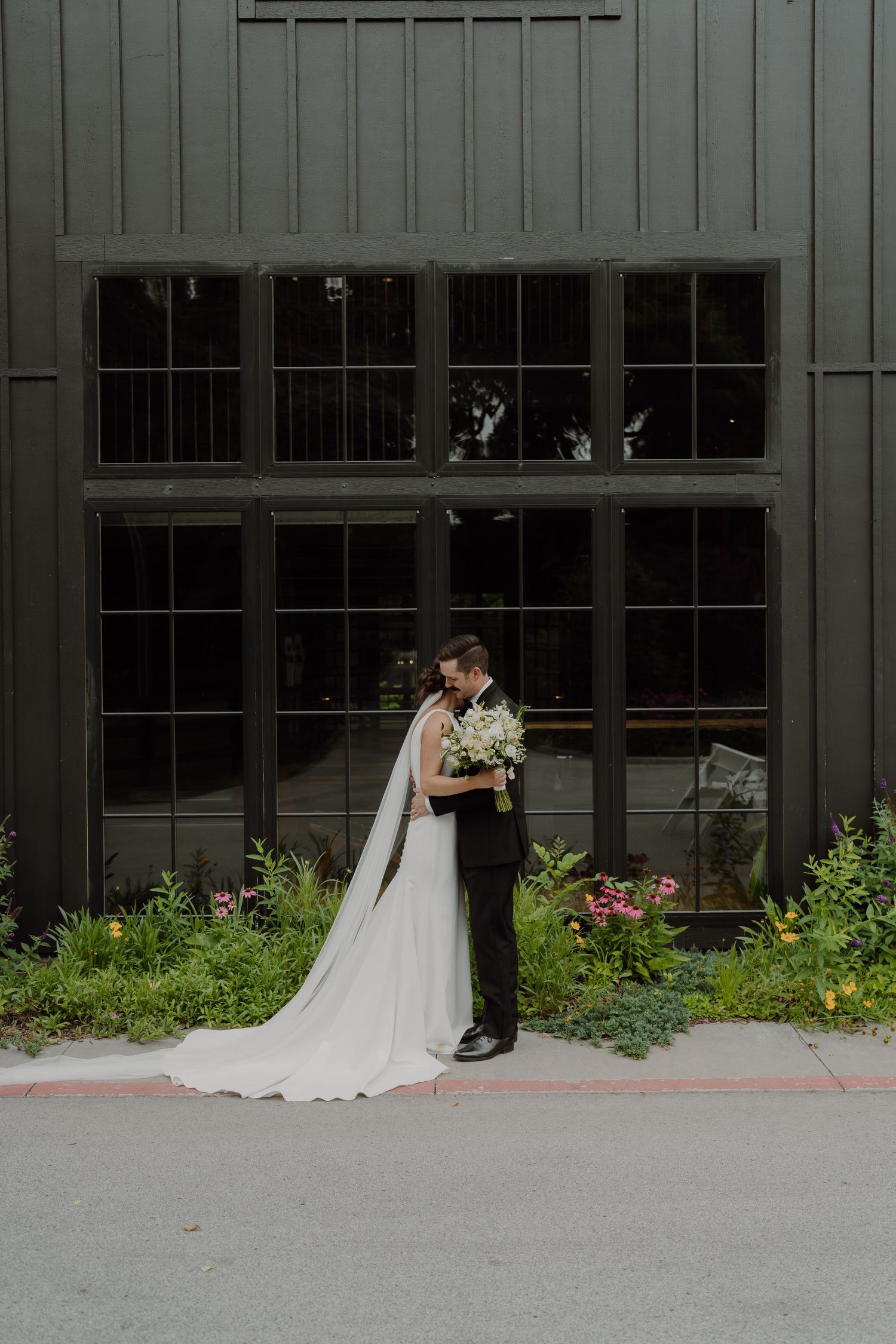 The modern barn venue Spain Ranch provides dramatic backdrop for wedding photography.