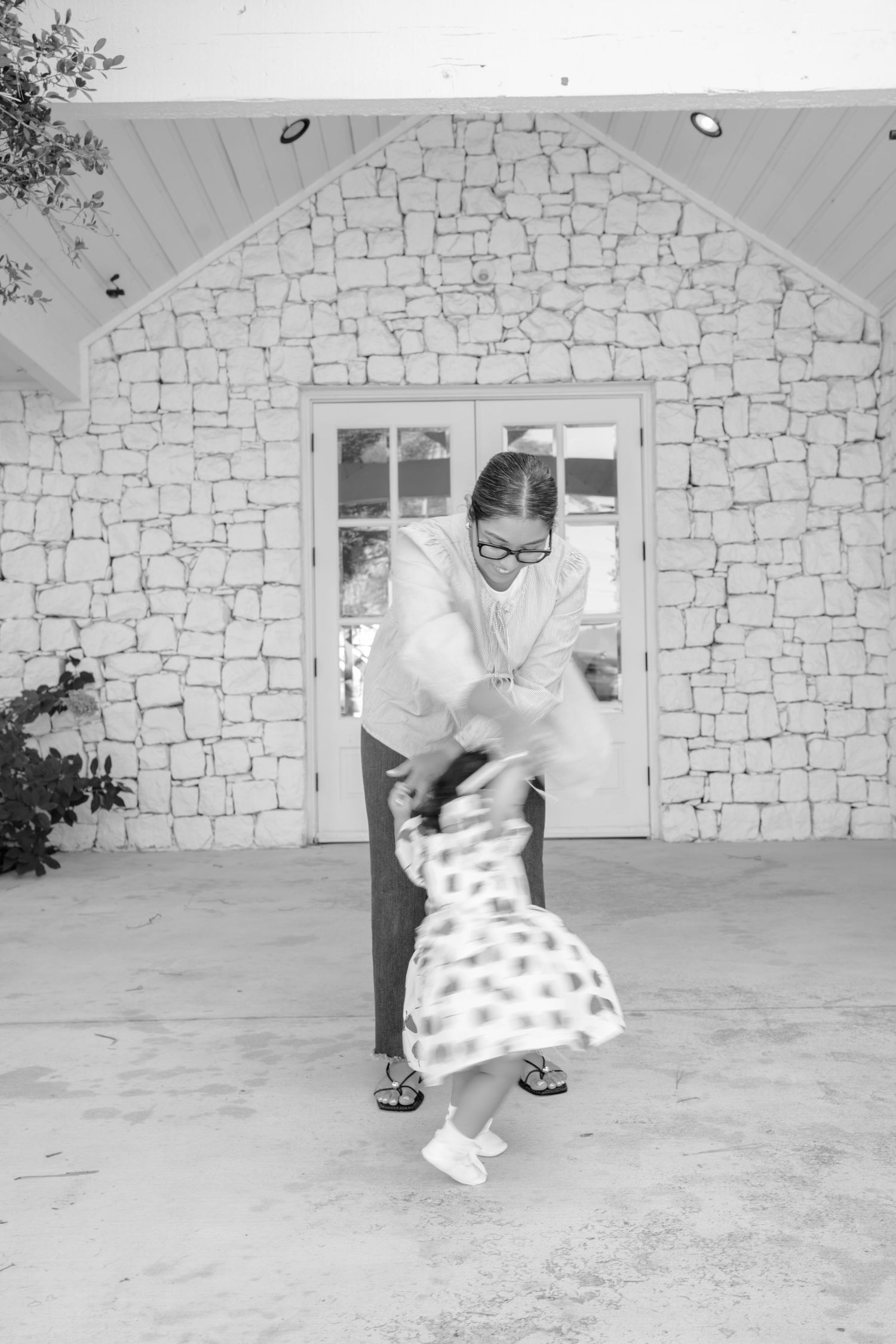Dancing sequence showing playful movements in front of white stone building.