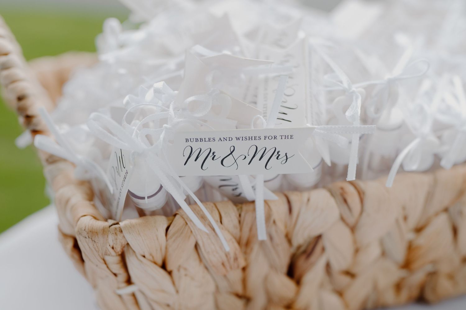 Close-up view of white wedding favor tags with decorative text.