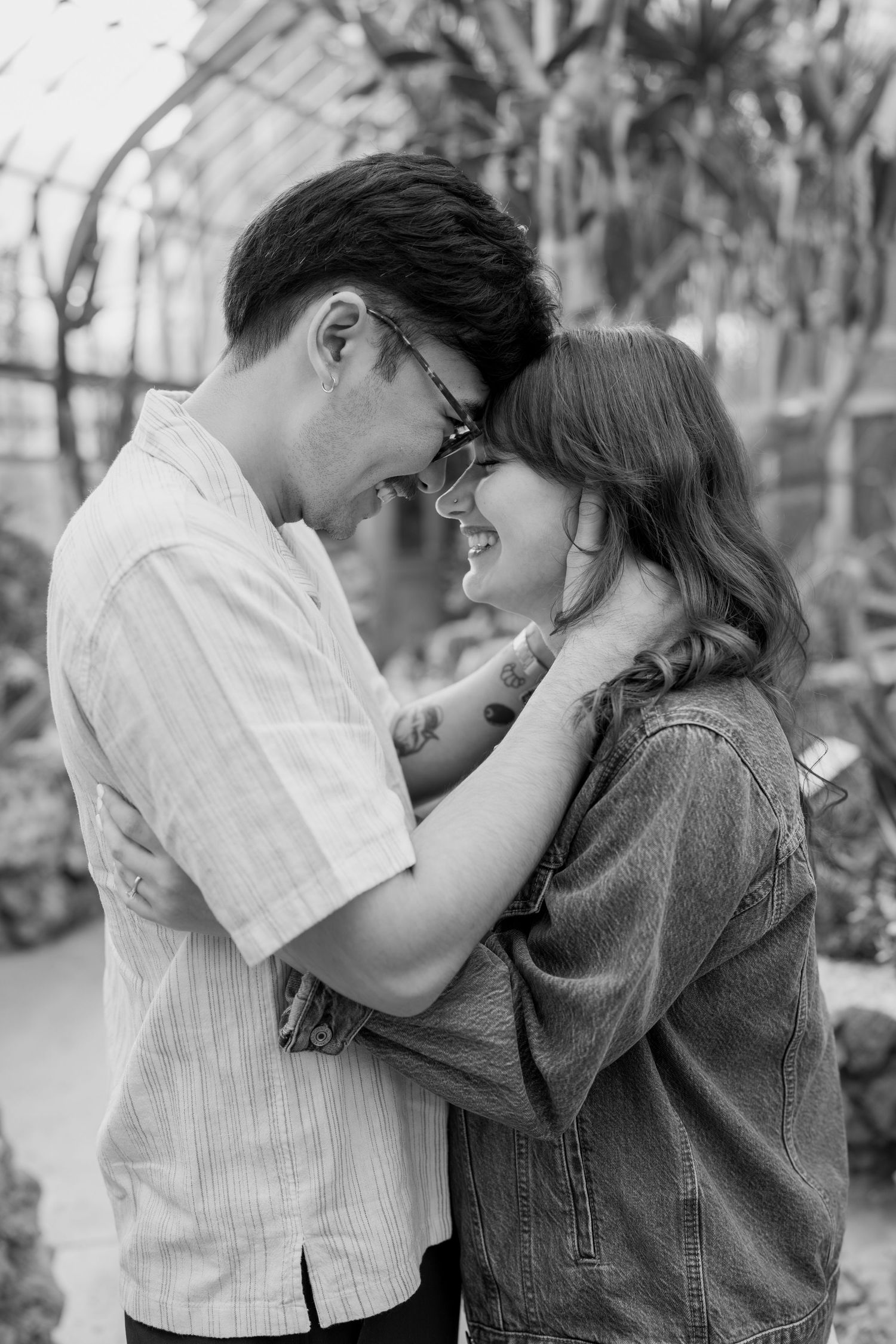 Black and white photos capture intimate moments between a couple in casual clothing.