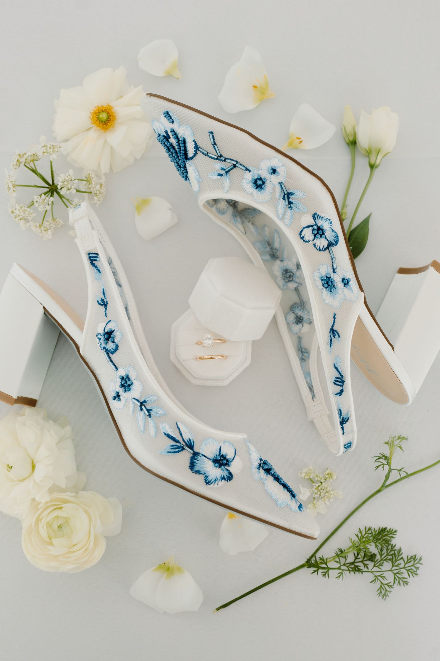 Handpainted ceramic decor with blue floral motifs alongside white roses and daisies.