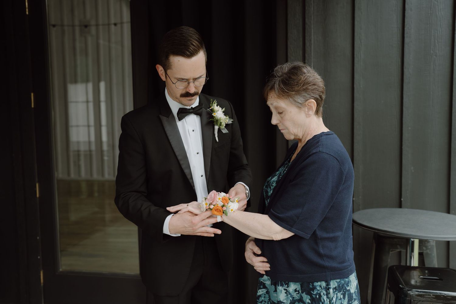 A sequence showing pre-wedding preparations with corsage pinning and adjustments.
