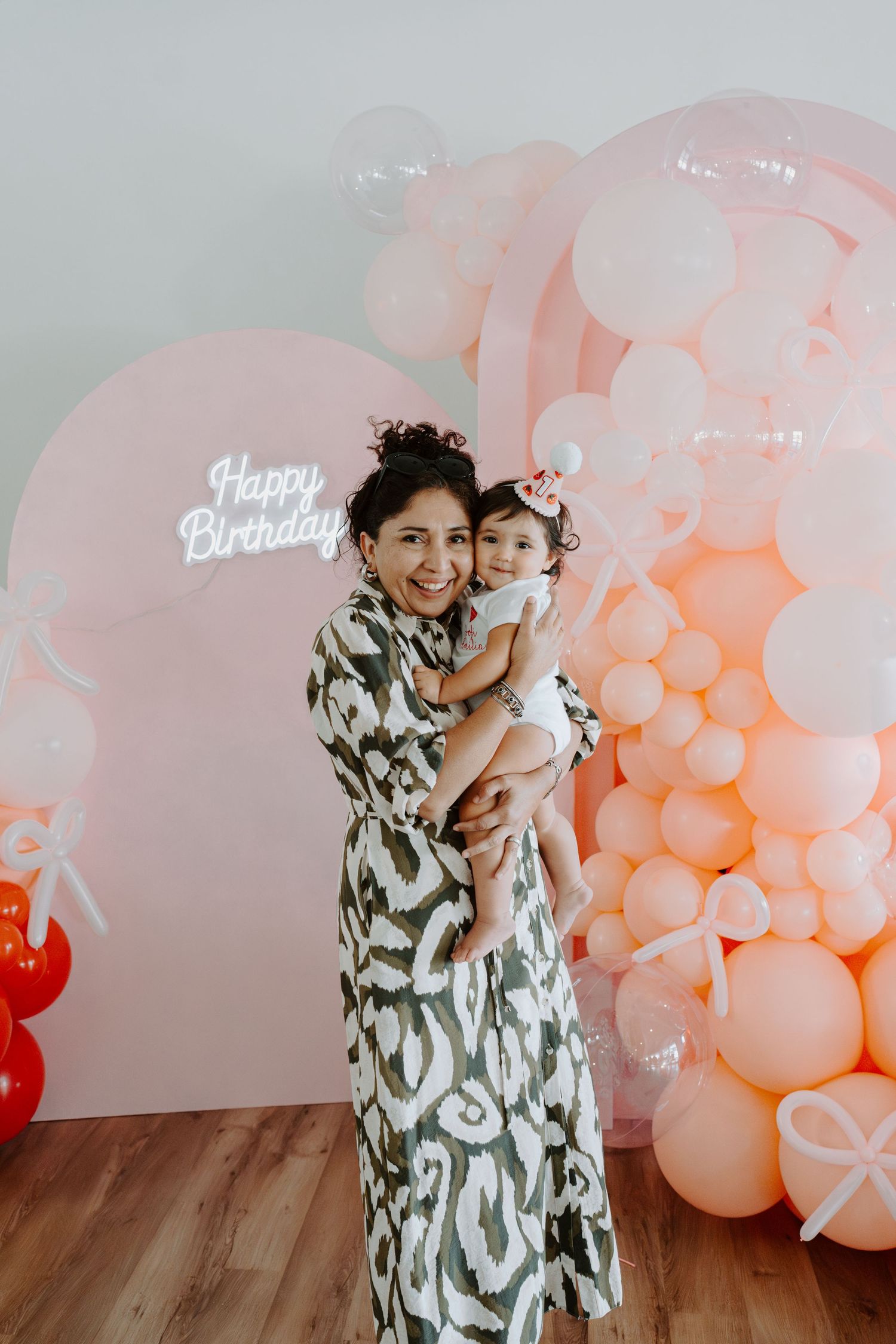 Special occasion photoshoot with beautiful coral and pink balloon installation.