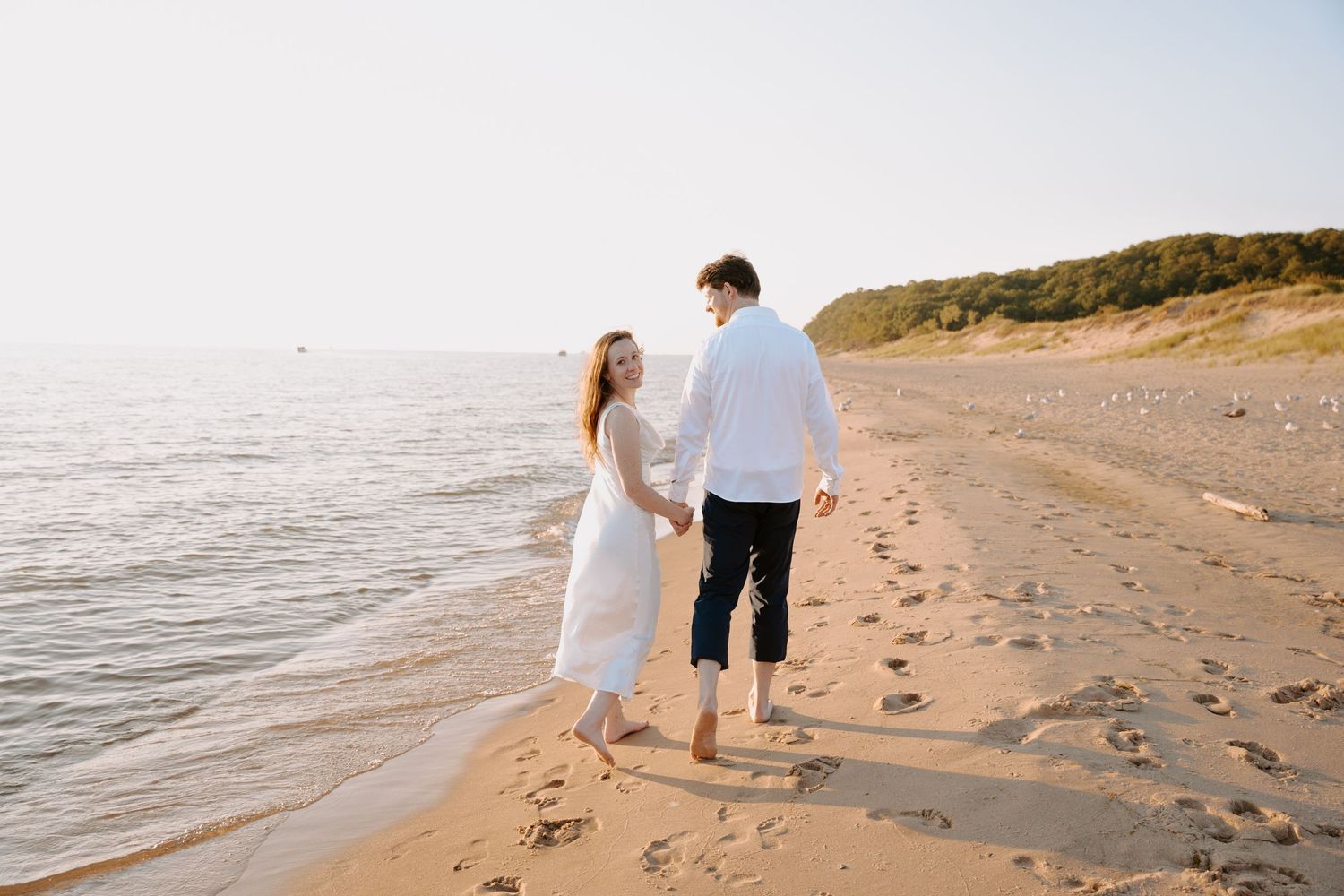 Couple enjoying a peaceful moment together on a sunlit beach.