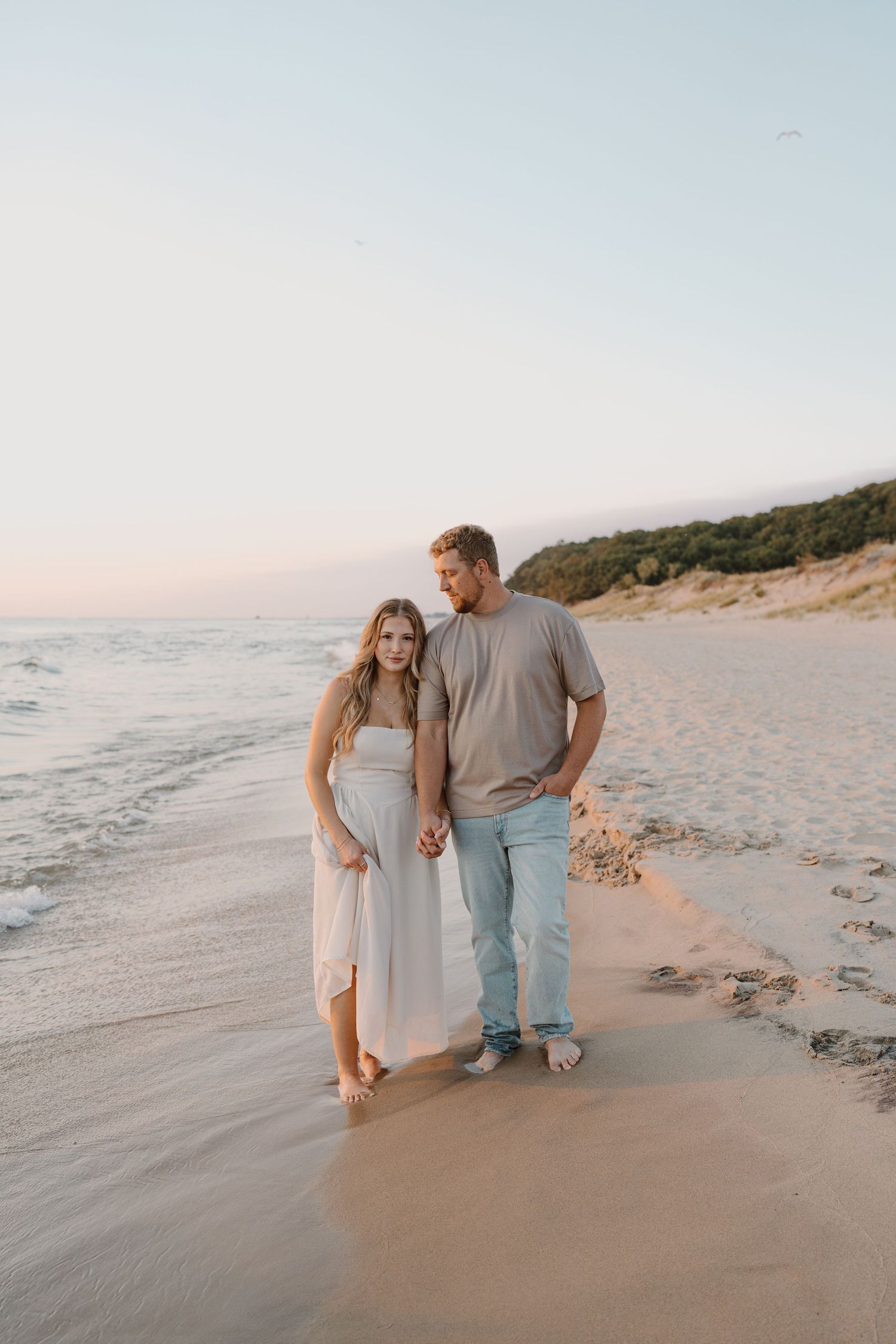 Romantic beach photography sequence showing a couple's casual stroll by the ocean.