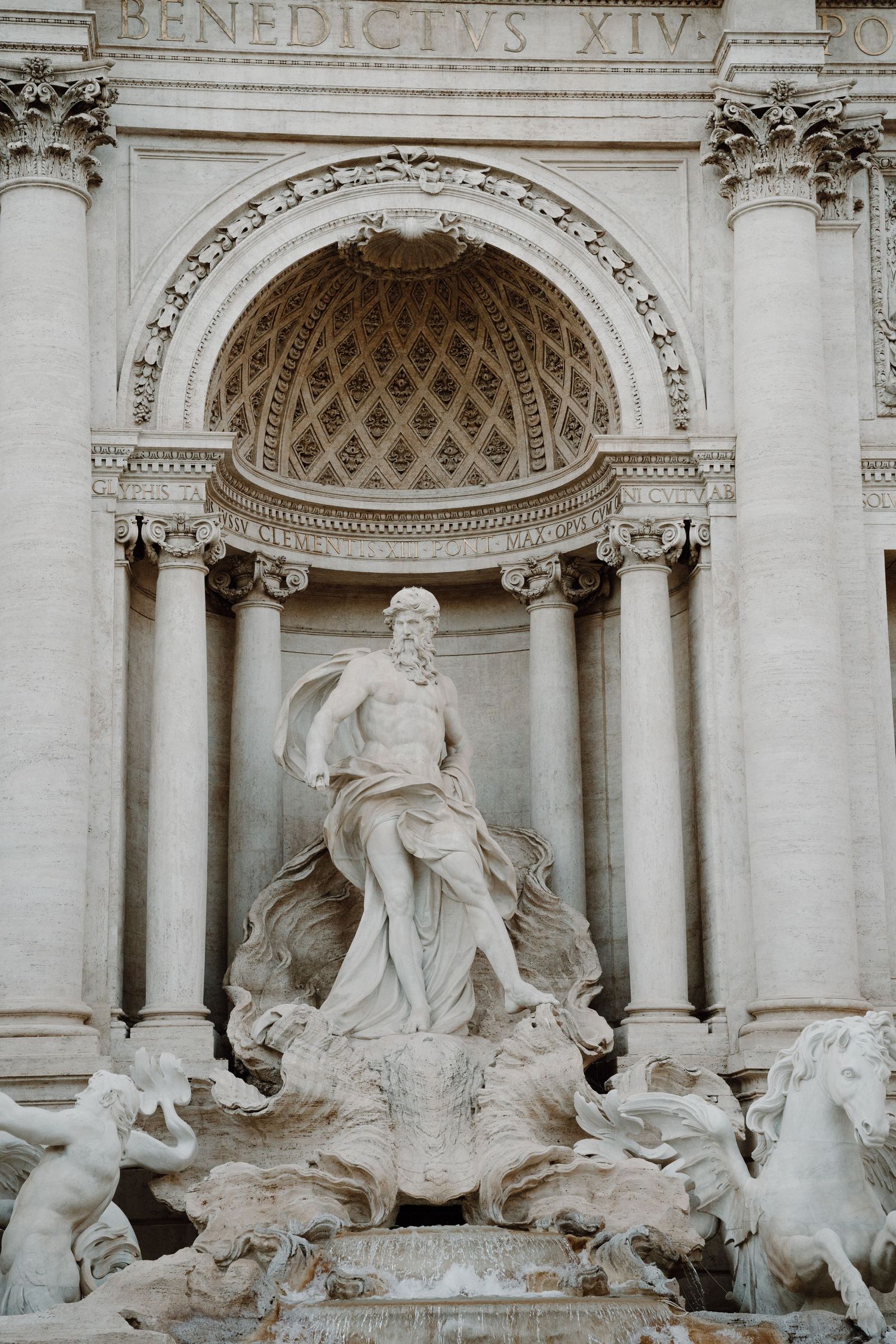Ornate Baroque sculptures and architectural details of the Trevi Fountain in Rome.