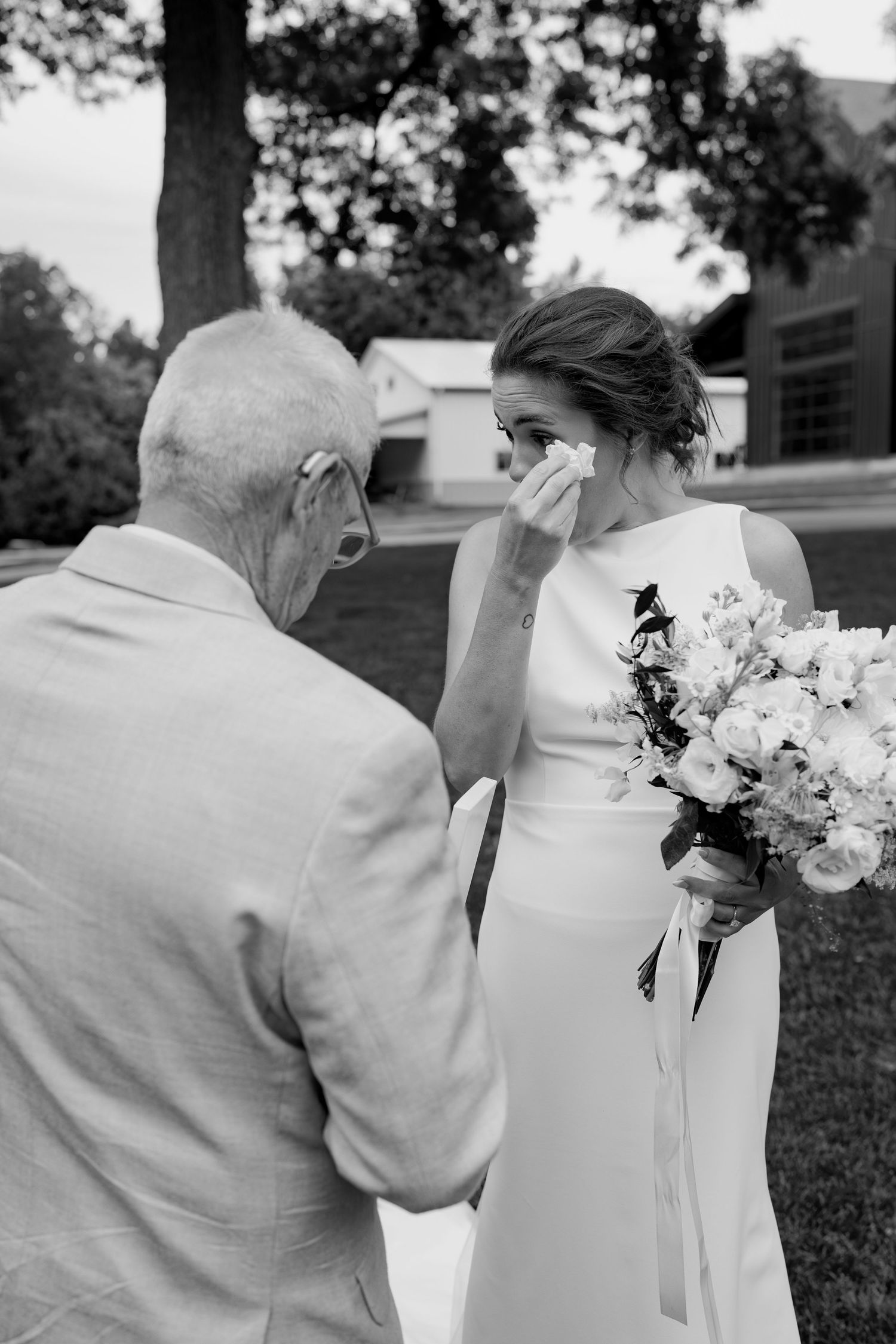 Black and white wedding photos showing intimate moments shared between two people with white flowers.