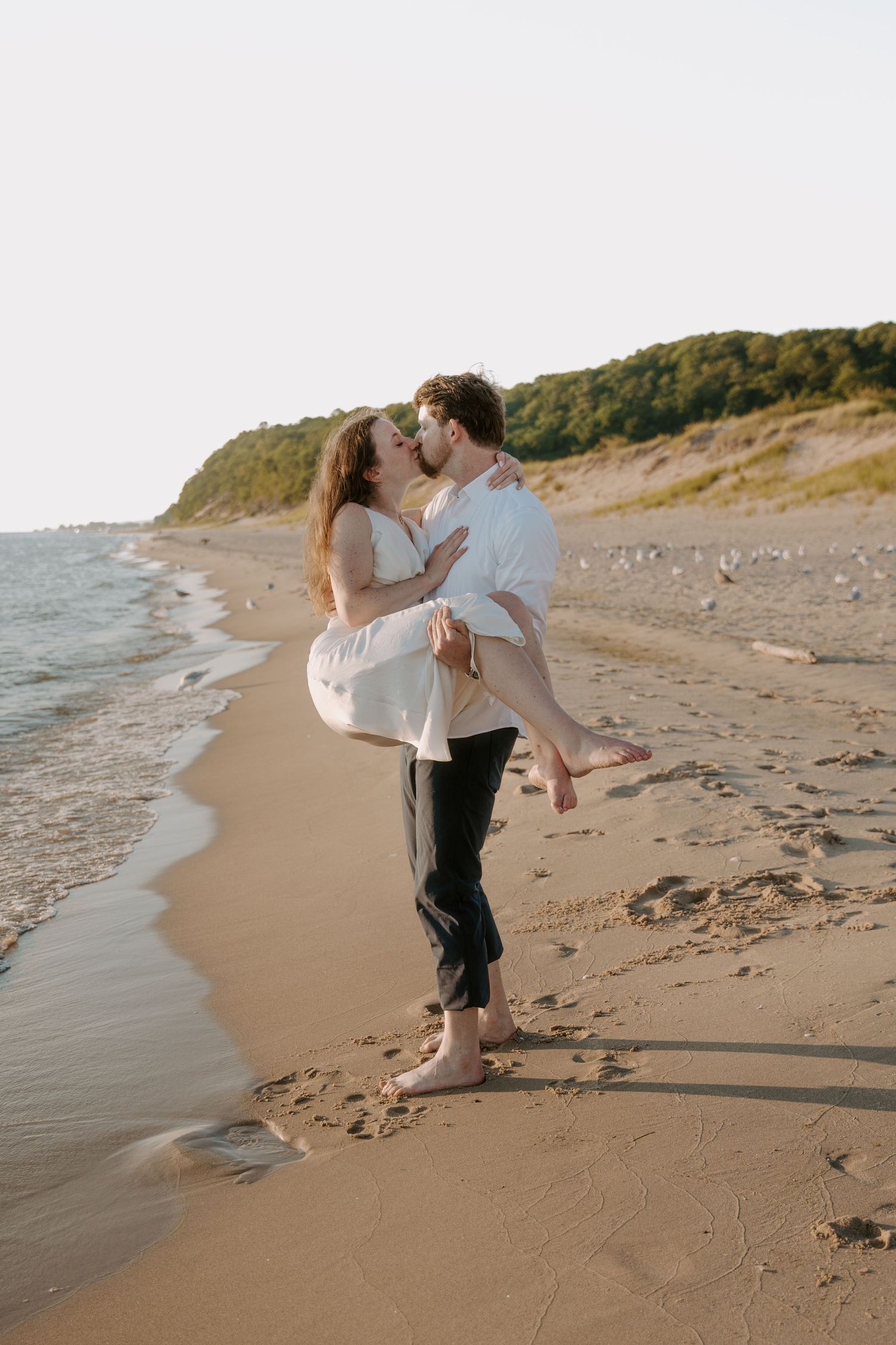 Intimate beachside moment with waves lapping at the shore.