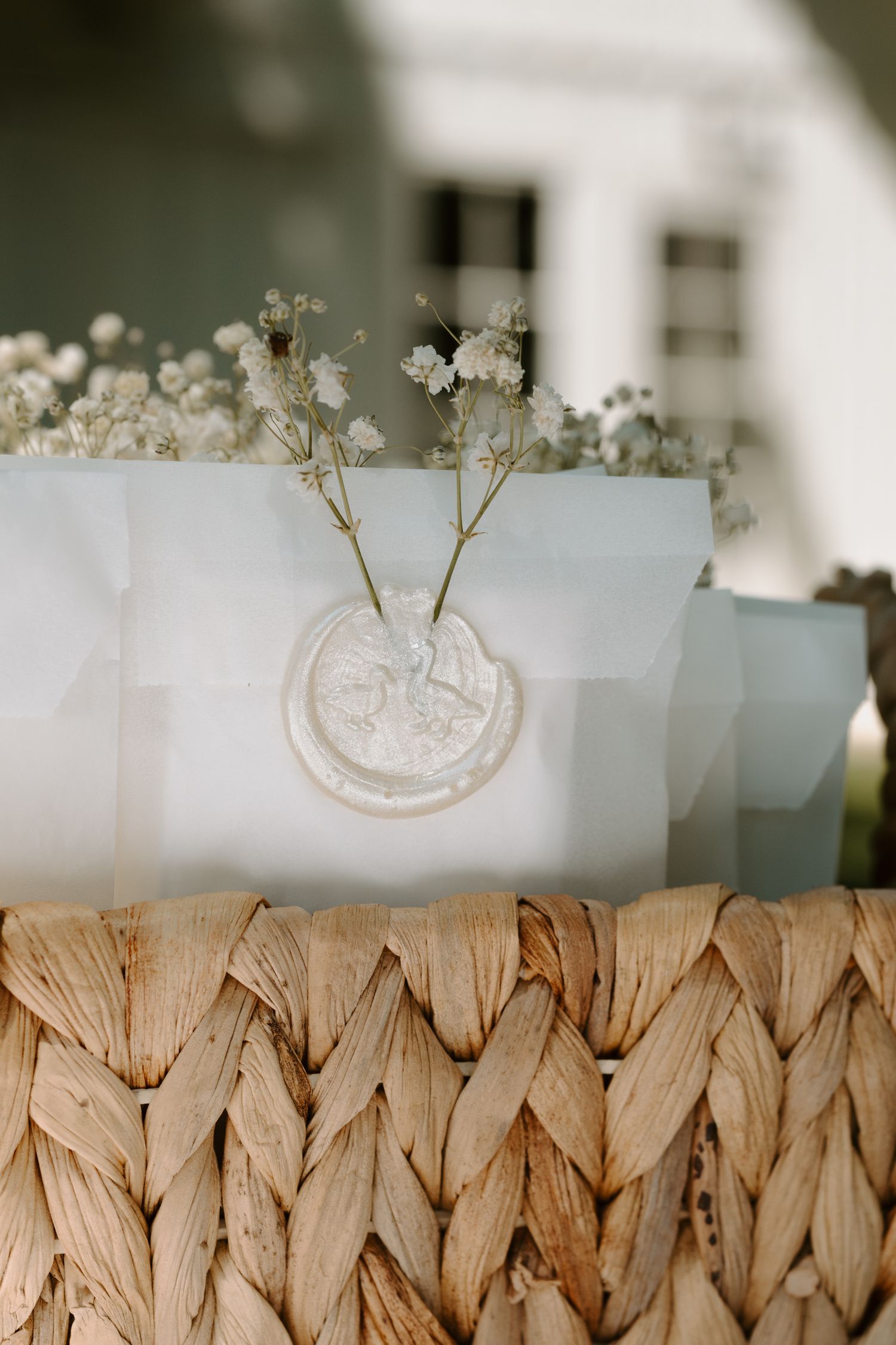 Delicate white baby's breath flowers arranged on textured woven surface.