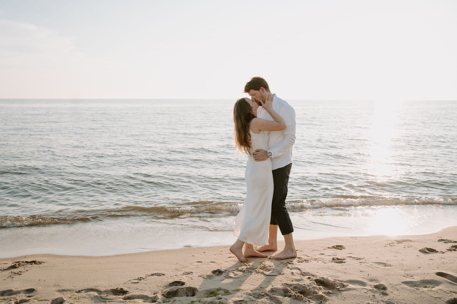 Romantic beach photoshoot sequence with couple against ocean backdrop.