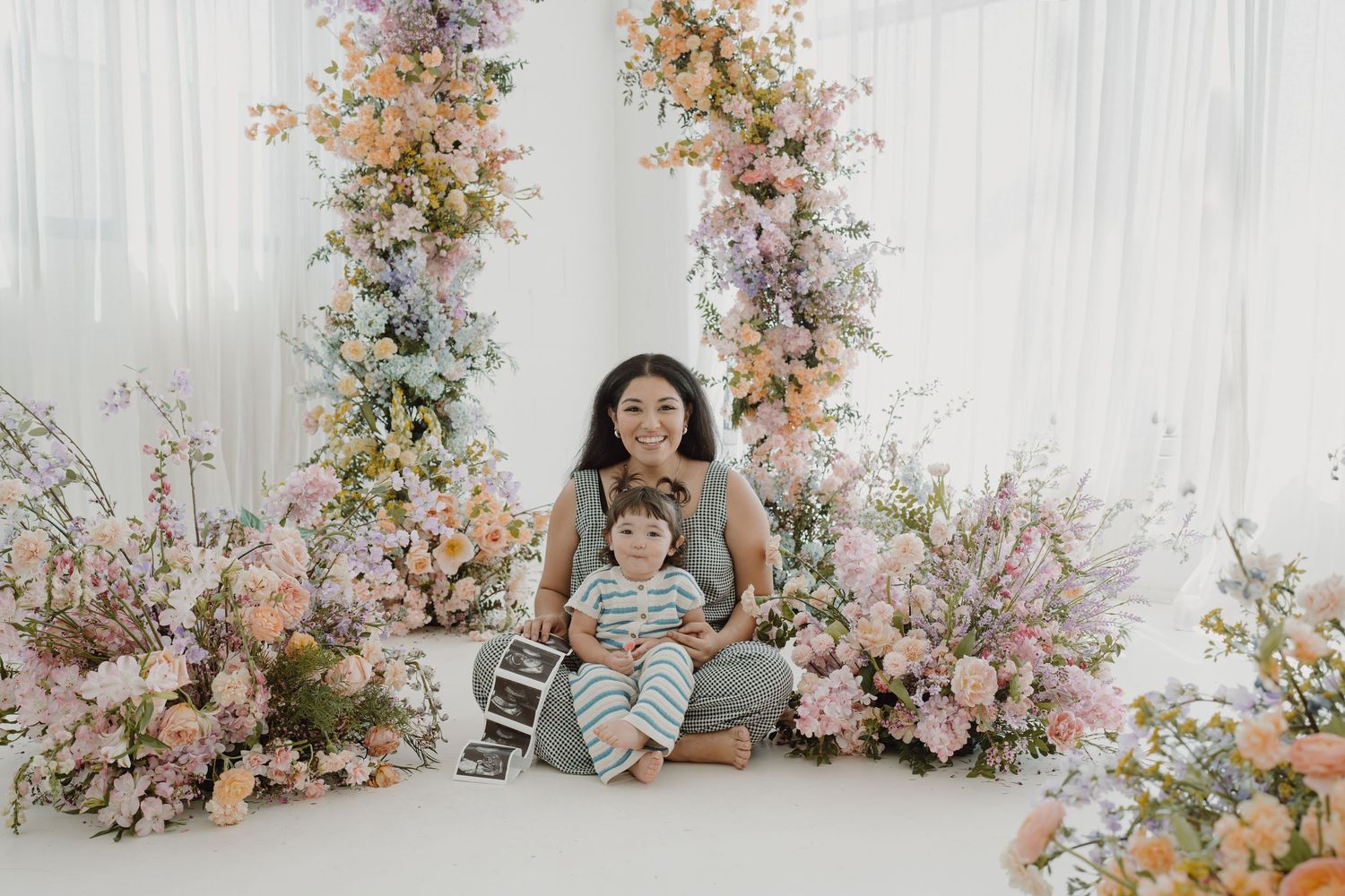 Beautiful floral studio setting with pink and peach blooms creating a romantic atmosphere.