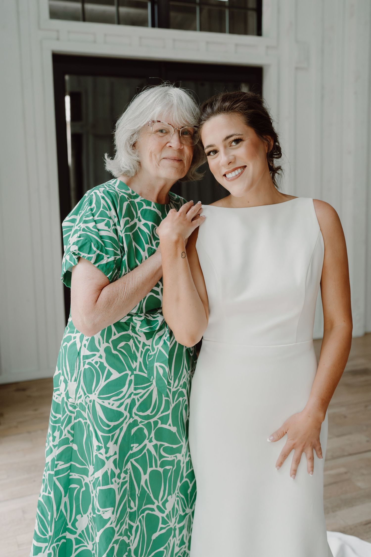 Candid moment of laughter and joy between two people during a wedding day celebration.