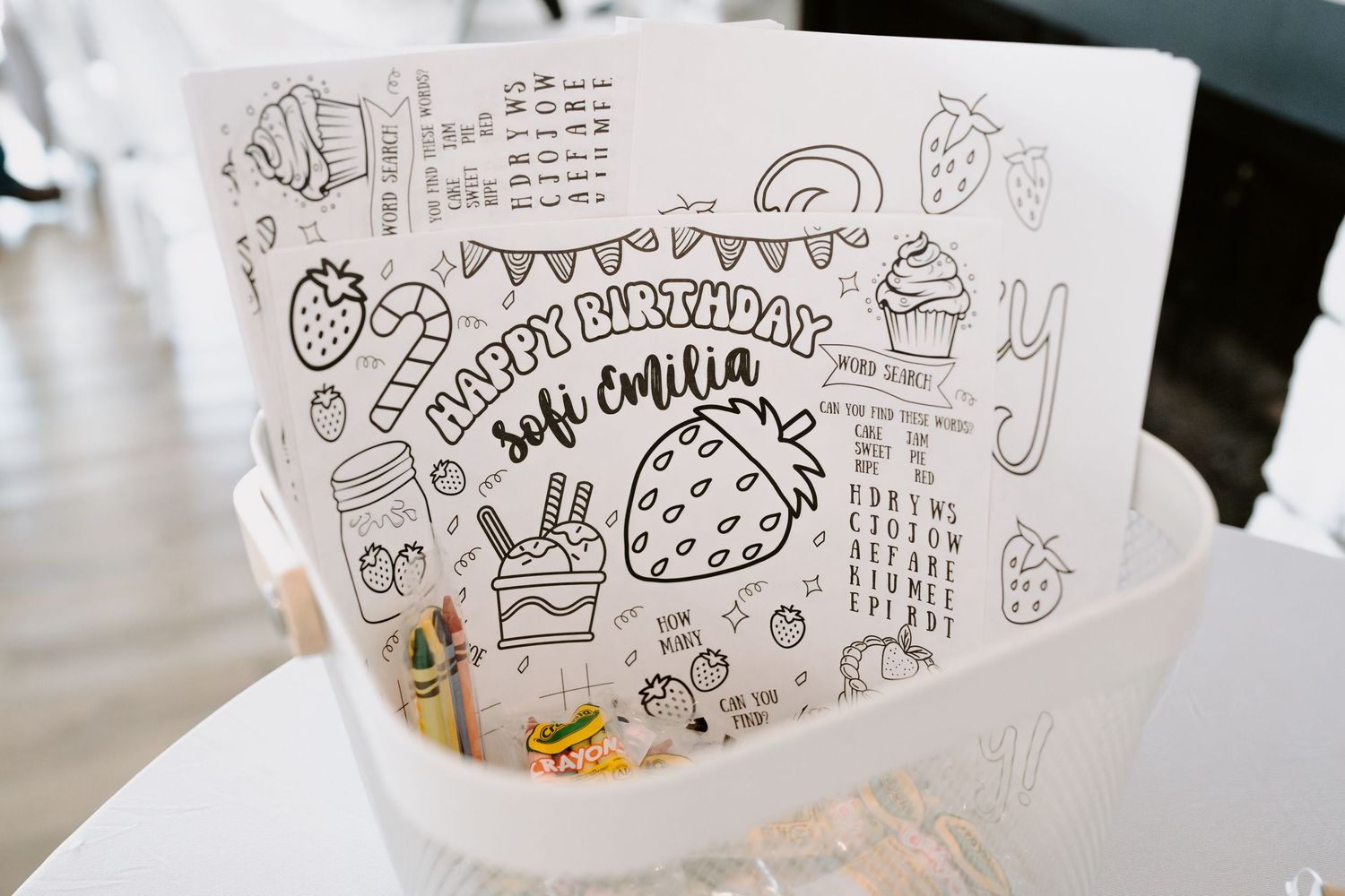Hand-drawn doodles and illustrations on white paper featuring strawberry designs.