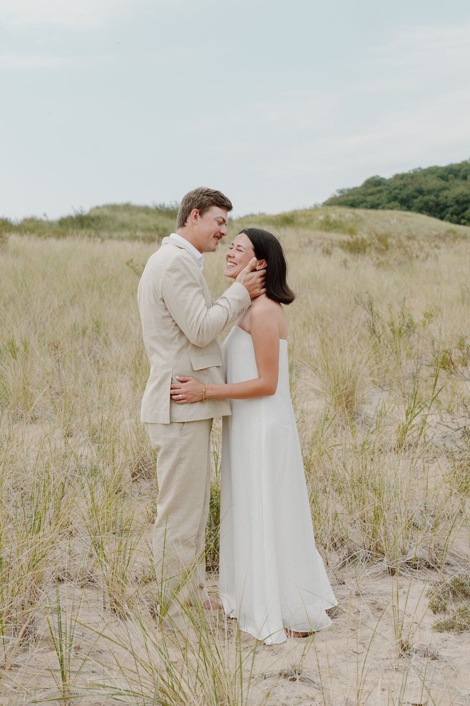 Intimate wedding photography sequence showing couple's loving interaction on a beach dune landscape.