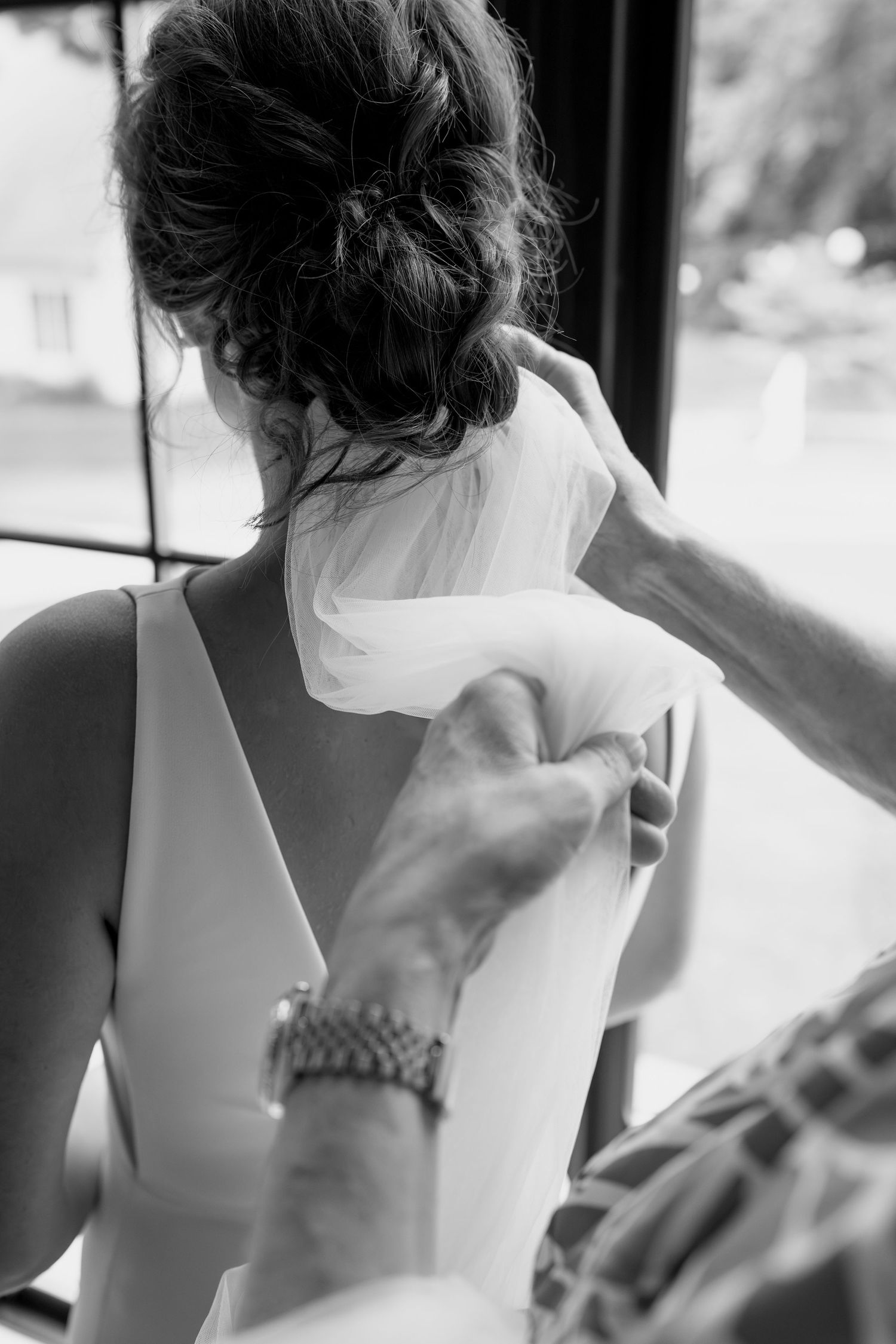 Sequence showing details of a modern sleeveless white wedding dress.
