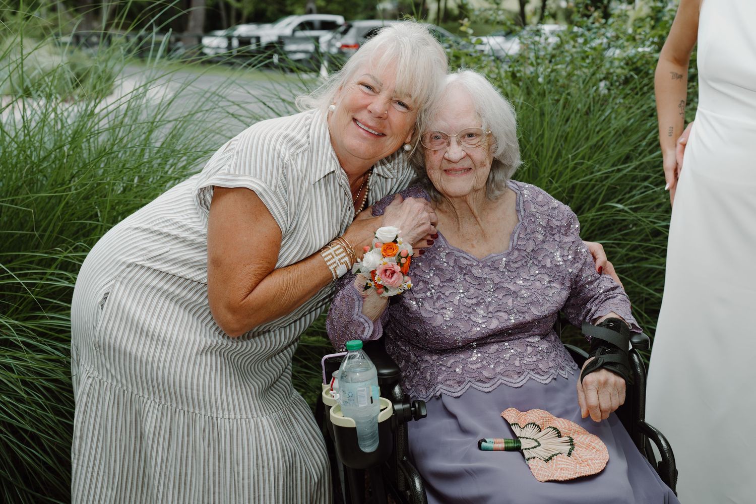Heartwarming moment shared between attendees at an outdoor celebration.
