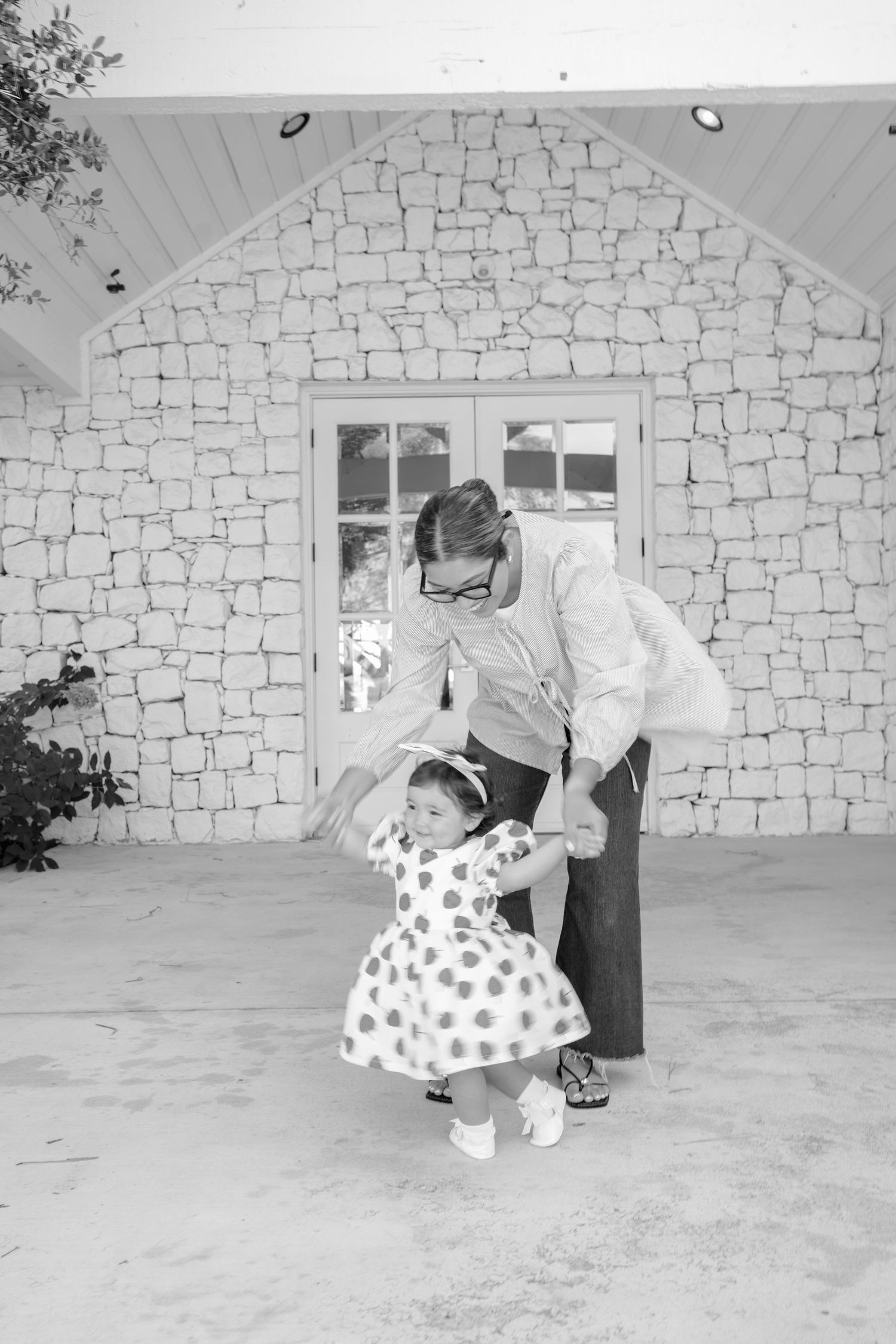 Monochrome sequence of dance moves captured in front of stone architecture.