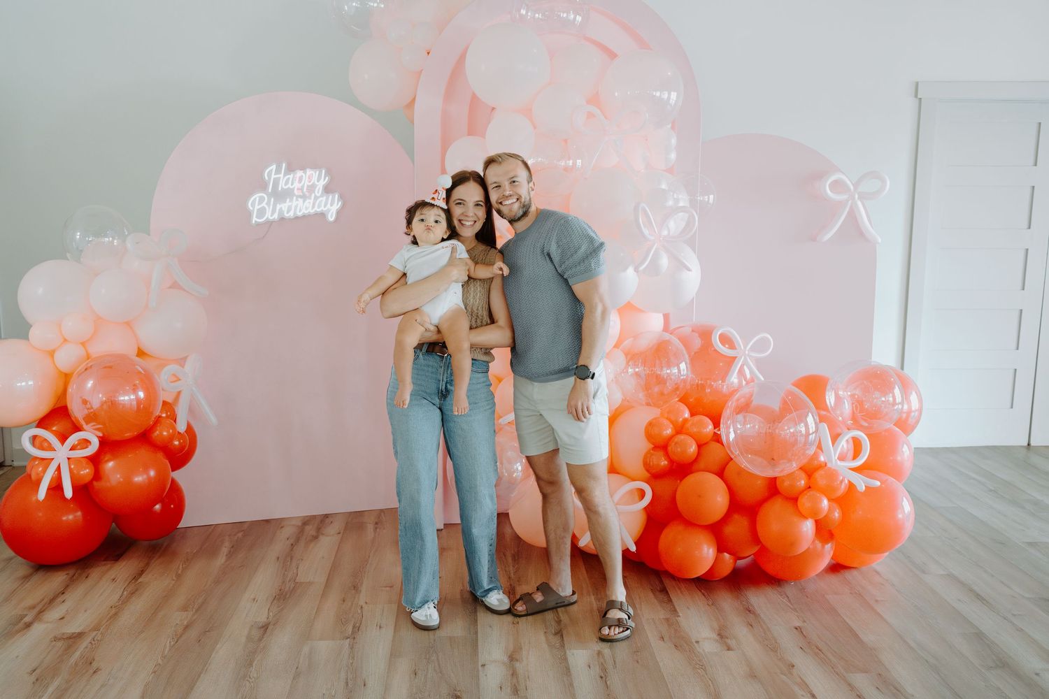 Professional photo session setup with elegant balloon arrangements in coral and blush tones.