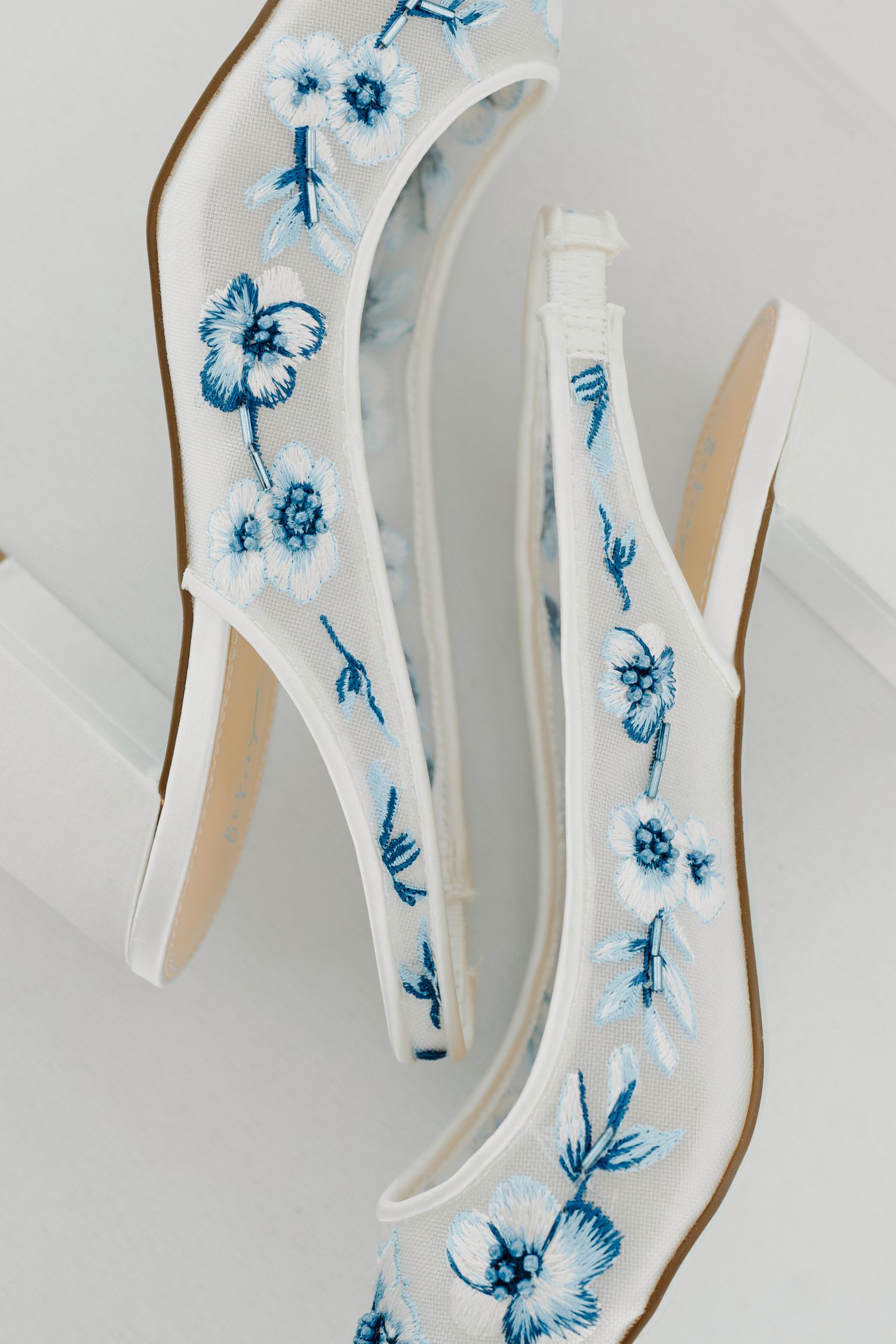 Decorative white ceramic piece featuring delicate blue floral patterns.