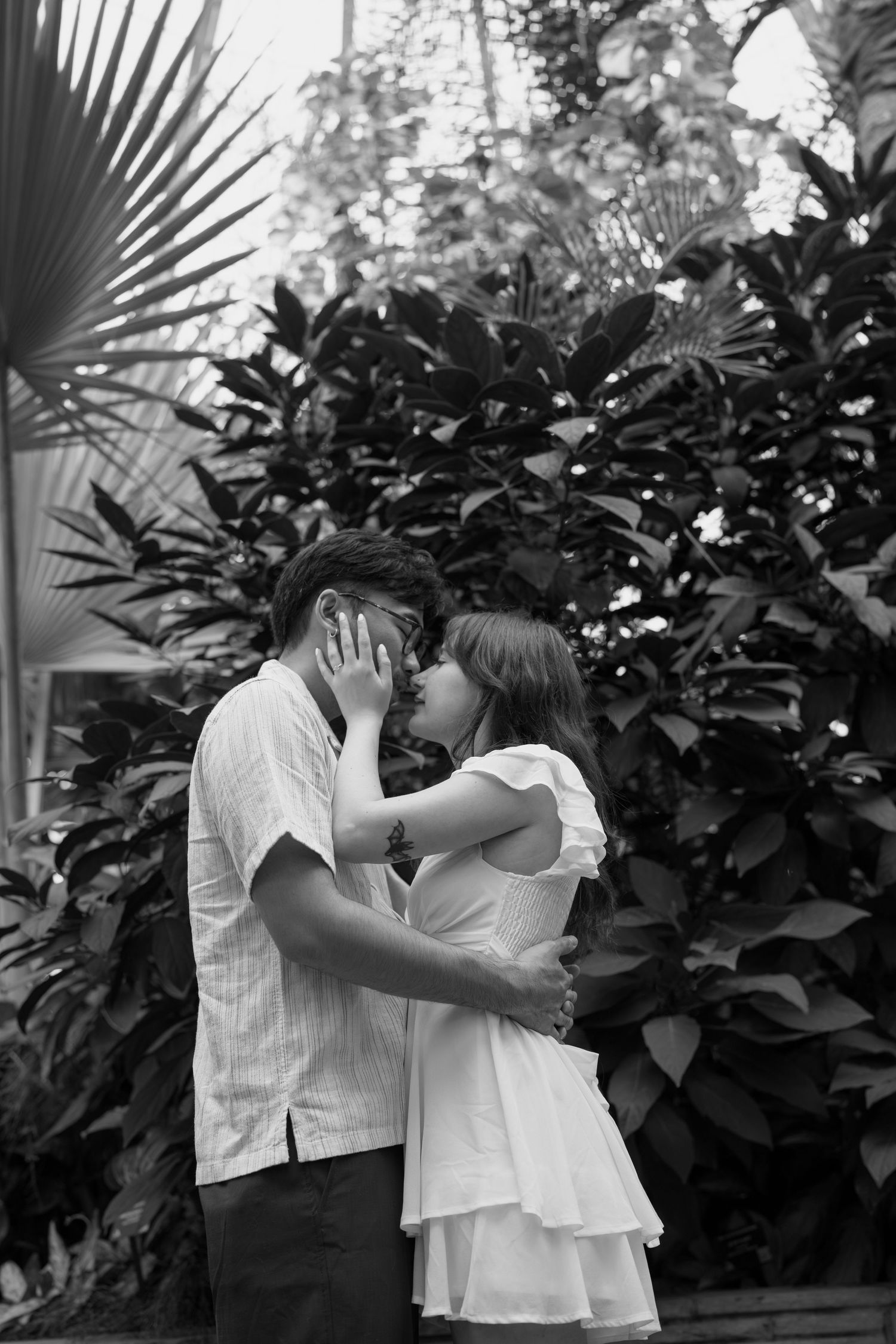 Black and white photos of intimate moments in a tropical garden setting.