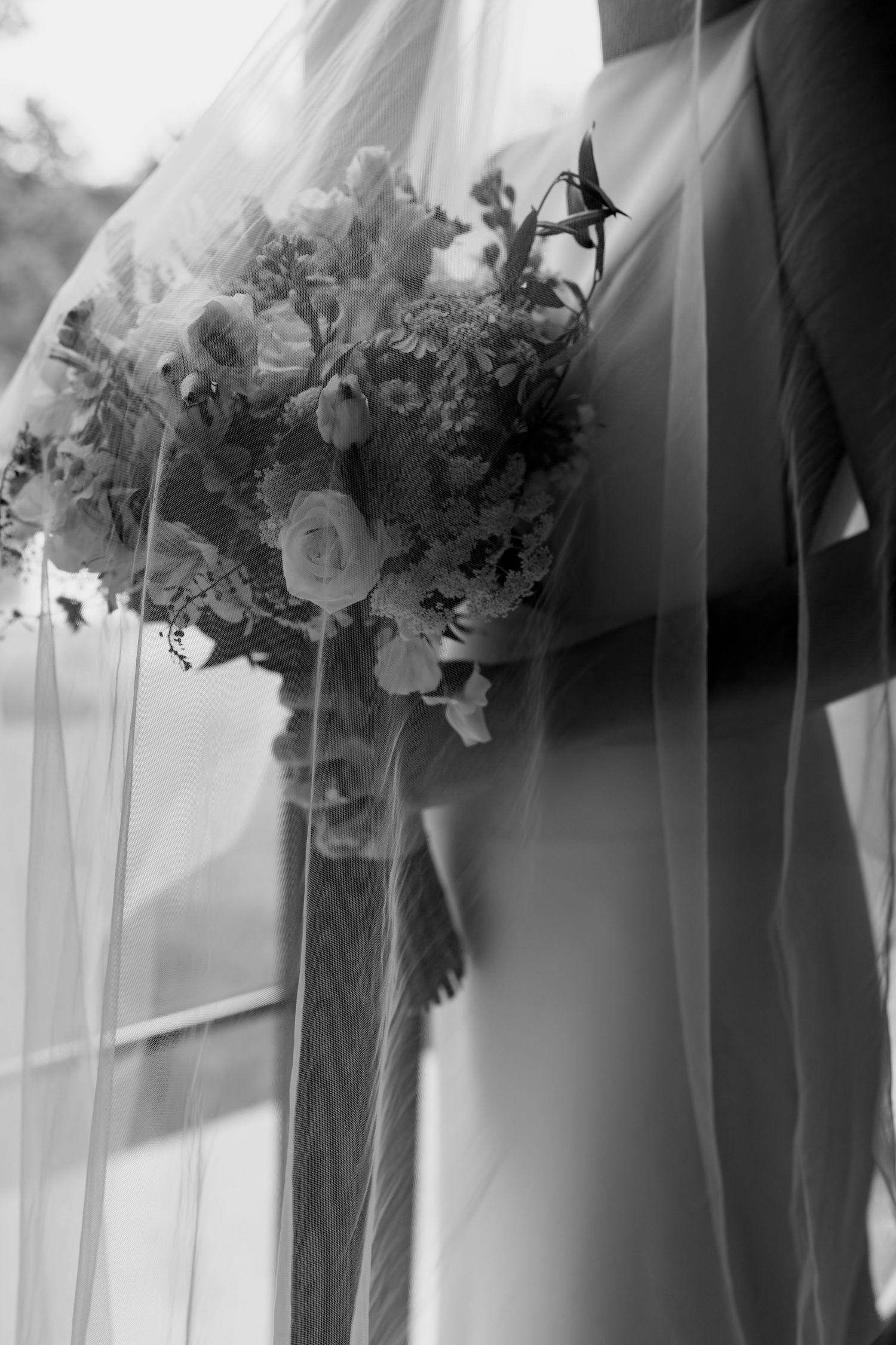 Row of elegant wedding bouquets in black and white photography.