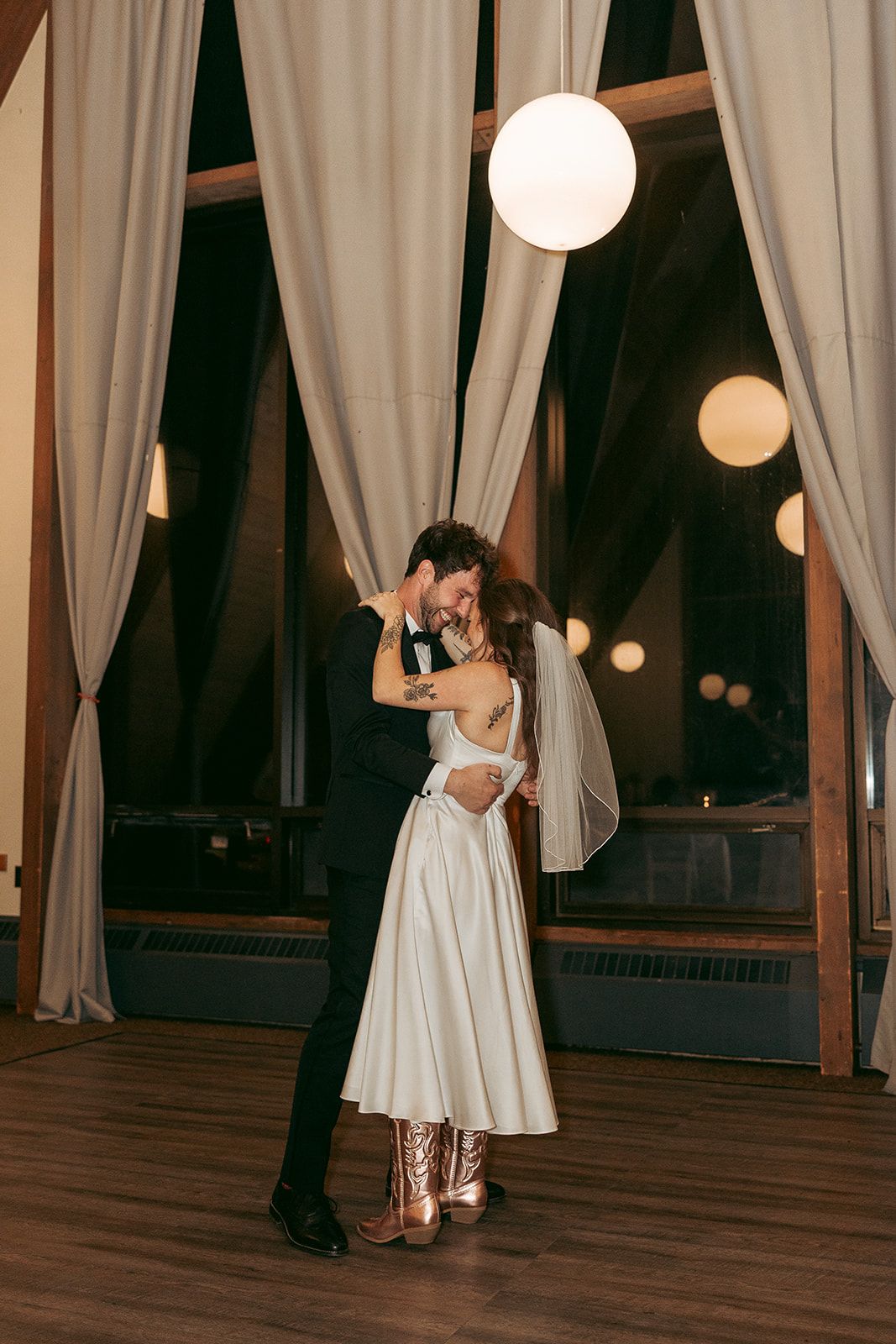 Emily and Noah's Wedding the bride and groom featuring the cowboy boots by Thomas and Co. Photography