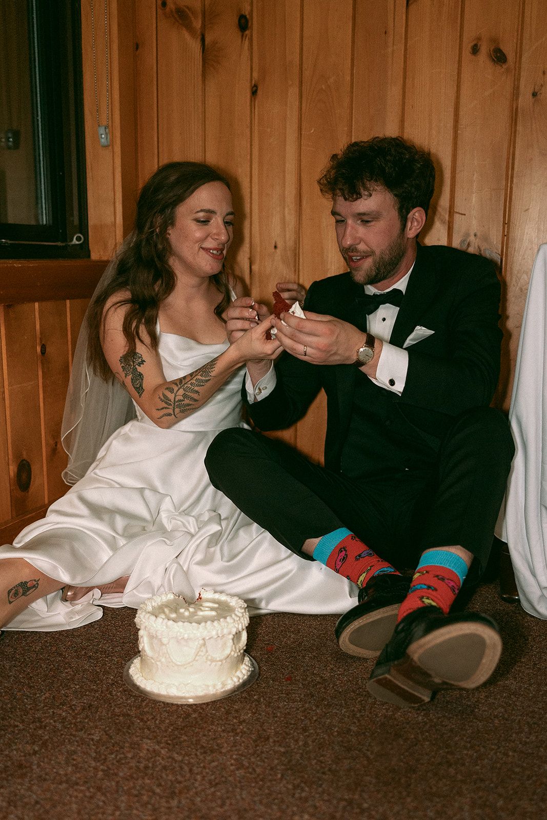 Emily and Noah's Wedding the cake on the floor by Thomas and Co. Photography