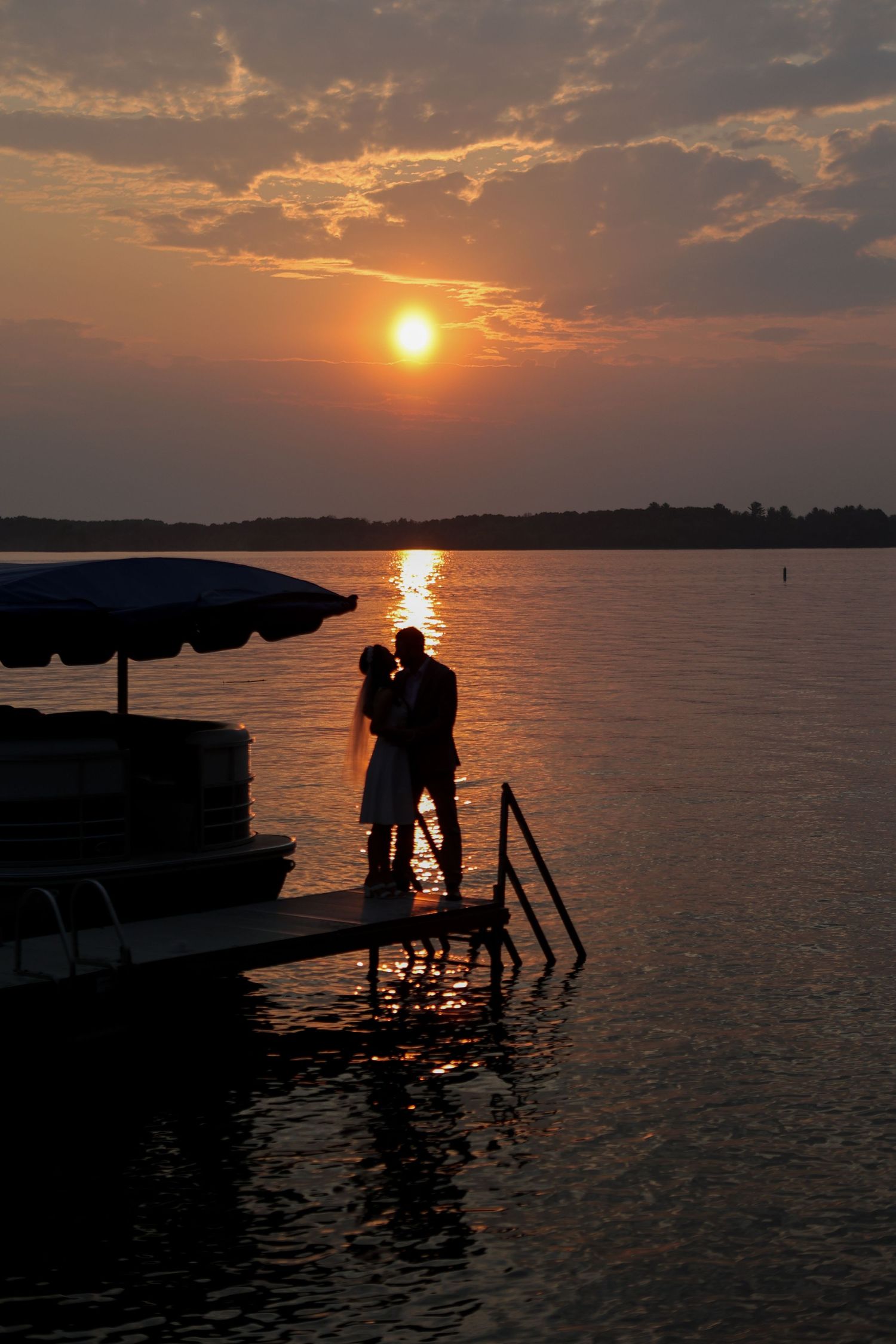 Backyard wedding photos, Wedding photos on a boat dock, just married couple standing on a boat dock at sunset, Emily Earll Photos