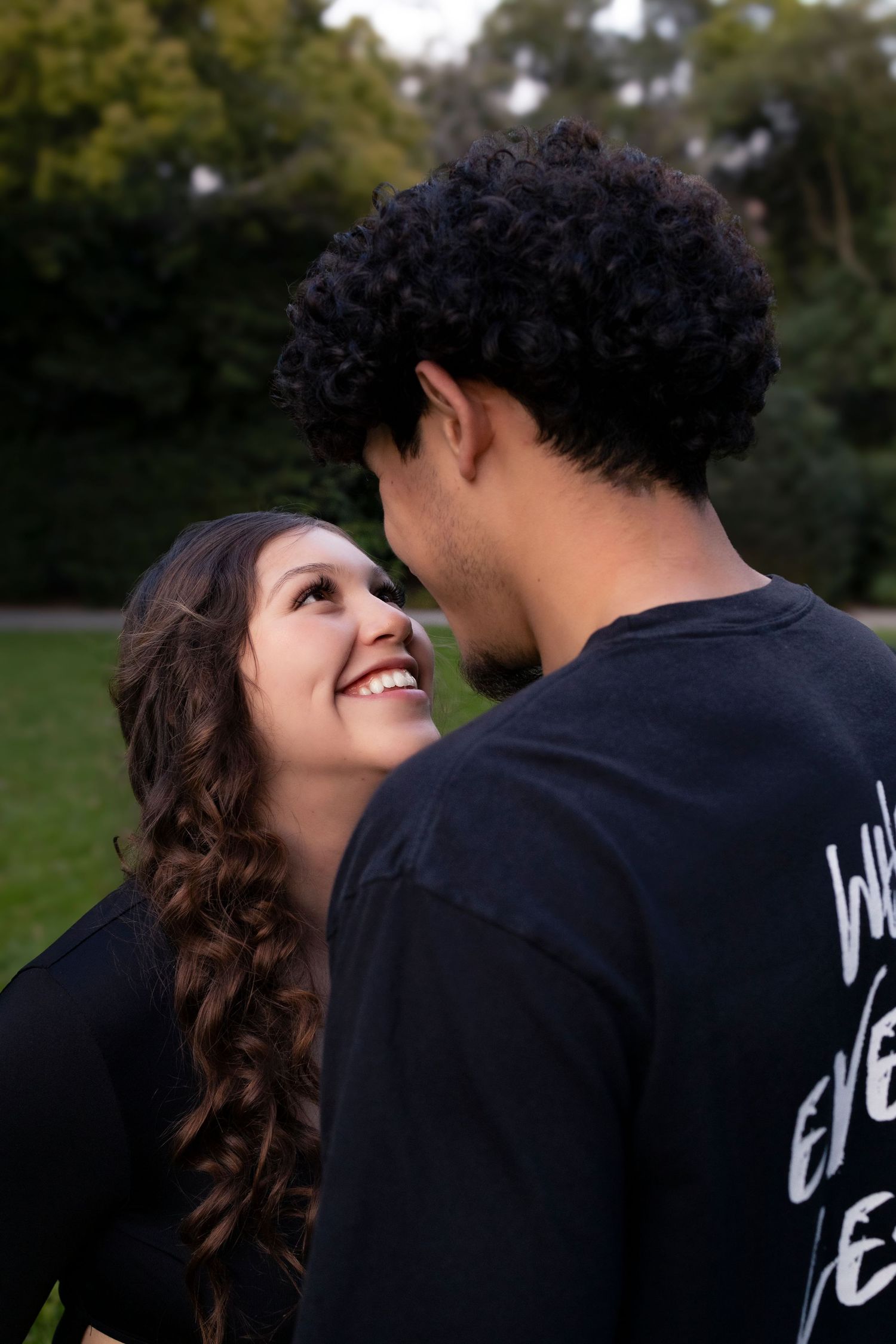 Candid laughing moments captured during outdoor couple's photoshoot.