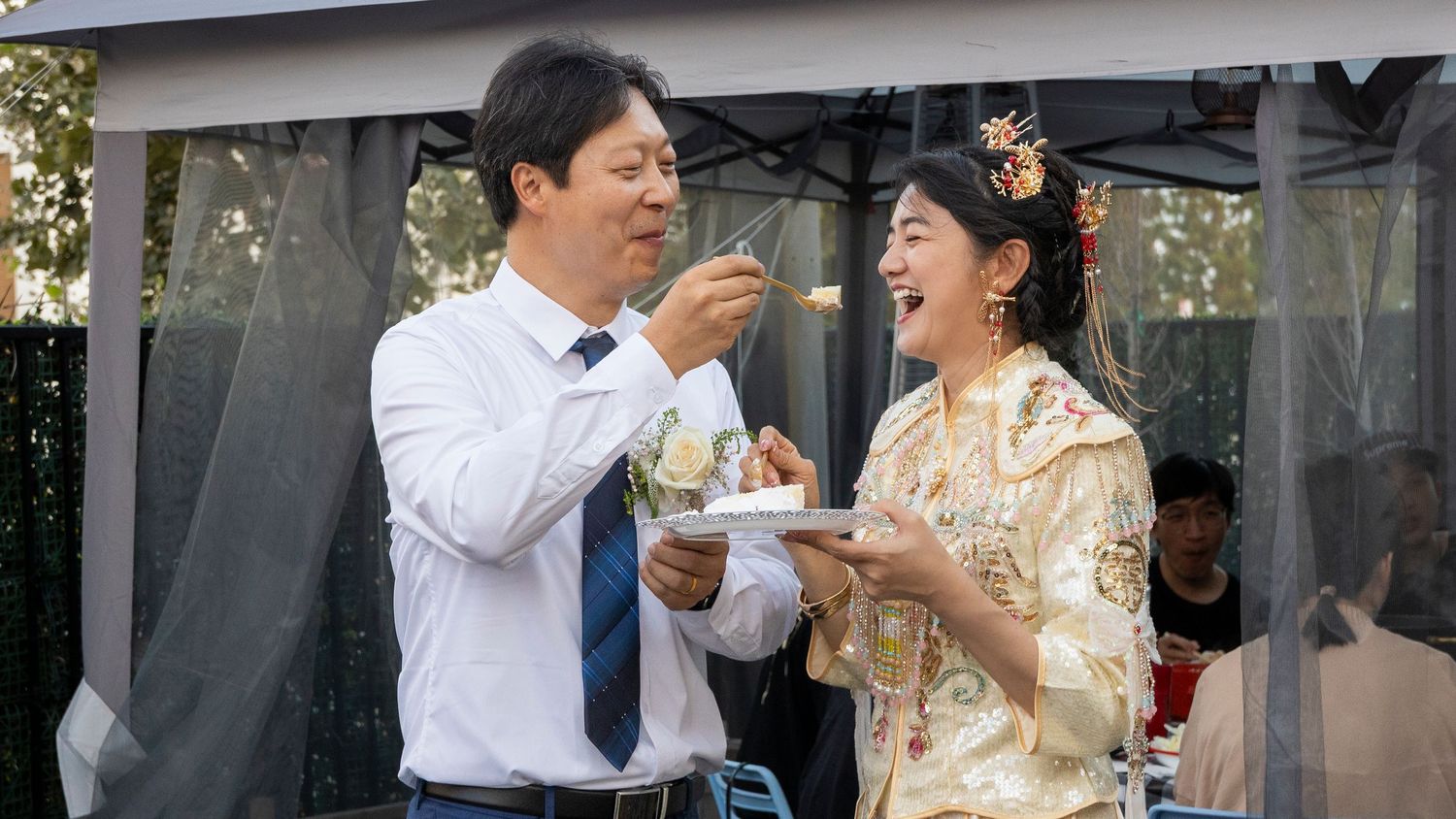 Outdoor wedding scene with decorative floral arrangements.