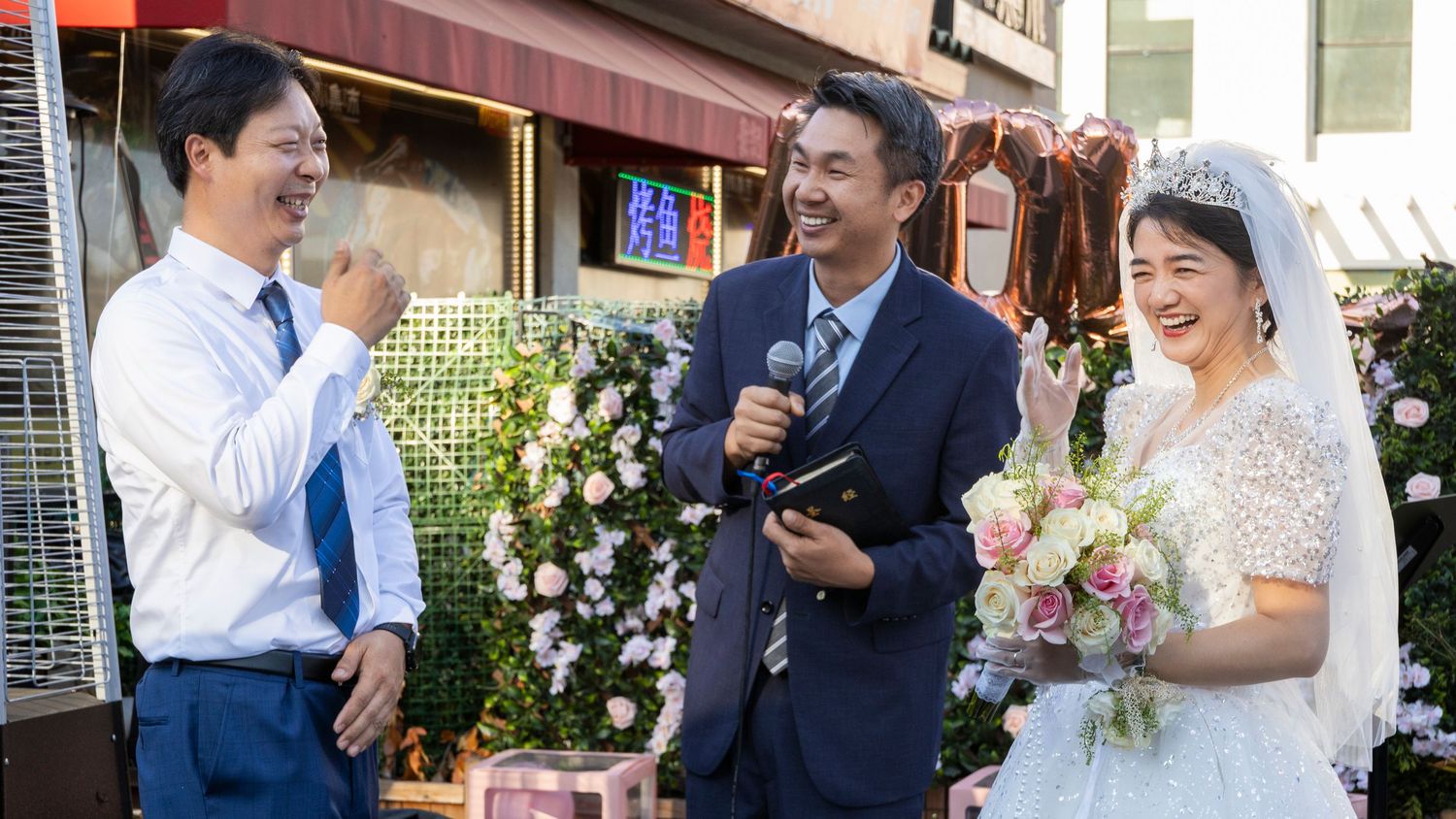 Outdoor wedding celebration with guests in formal attire enjoying the festivities.