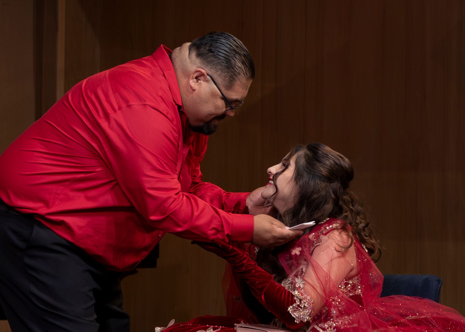 Celebration scene with red formal attire and elegant decor.