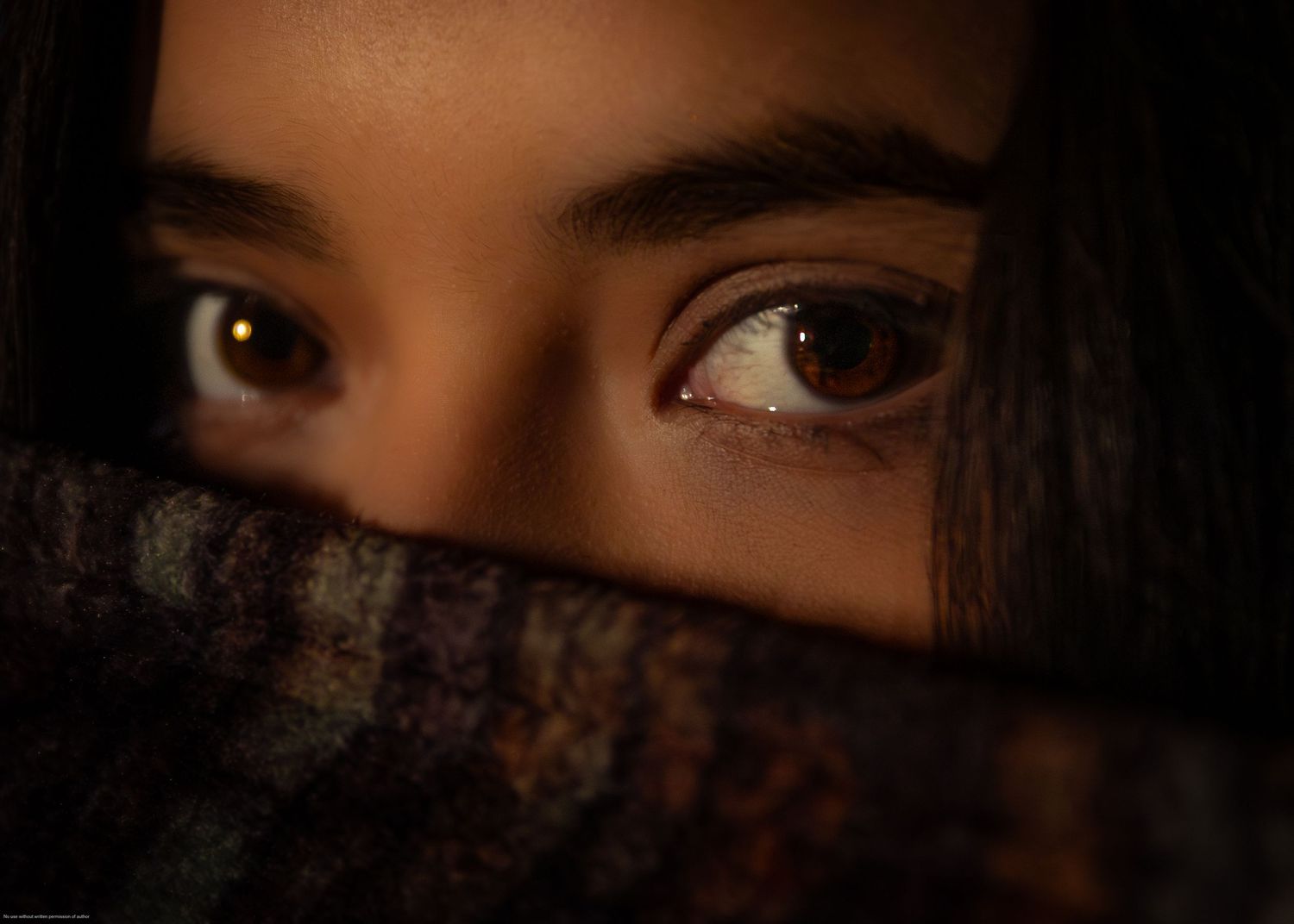 Artistic close-up photo focused on eyes with partially covered face.
