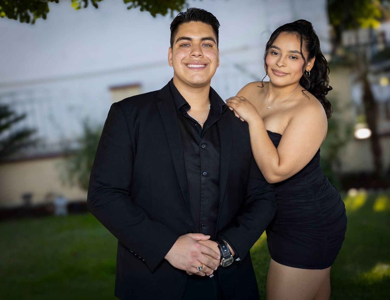 Well dressed couple standing next to each other. Formal couples portrait