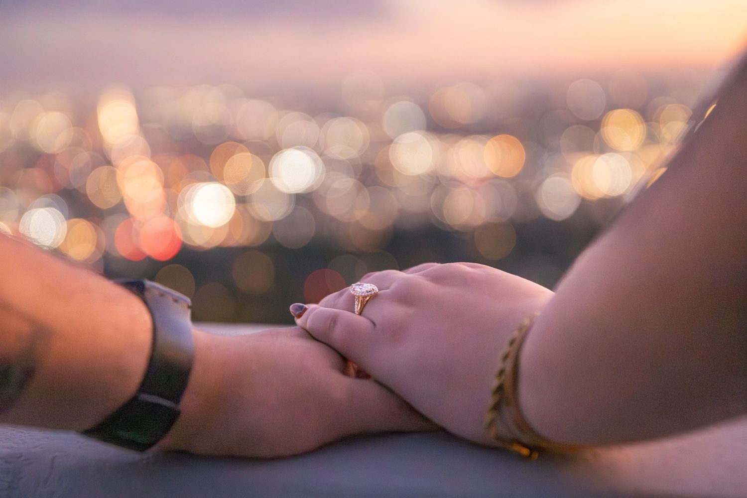 Blurred bokeh city lights create a dreamy urban nightscape background with soft warm tones.