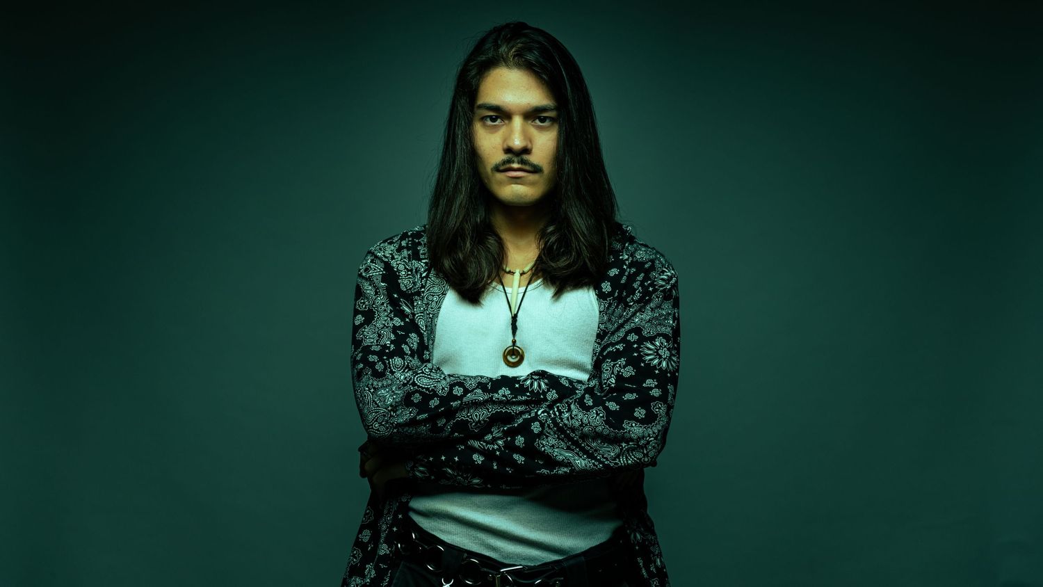 A series of dark moody portraits with teal lighting against a black background.