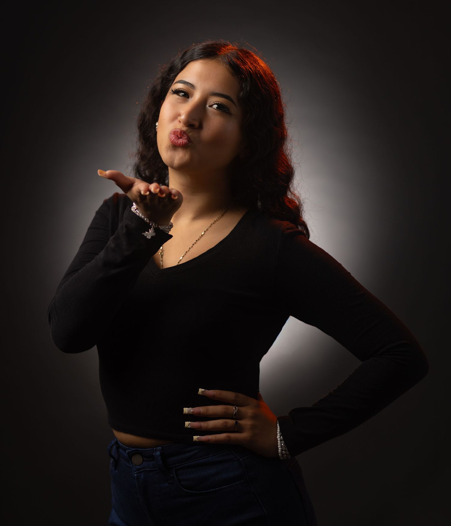 Dramatic portrait series showing artistic poses against dark background with moody lighting and shadows.