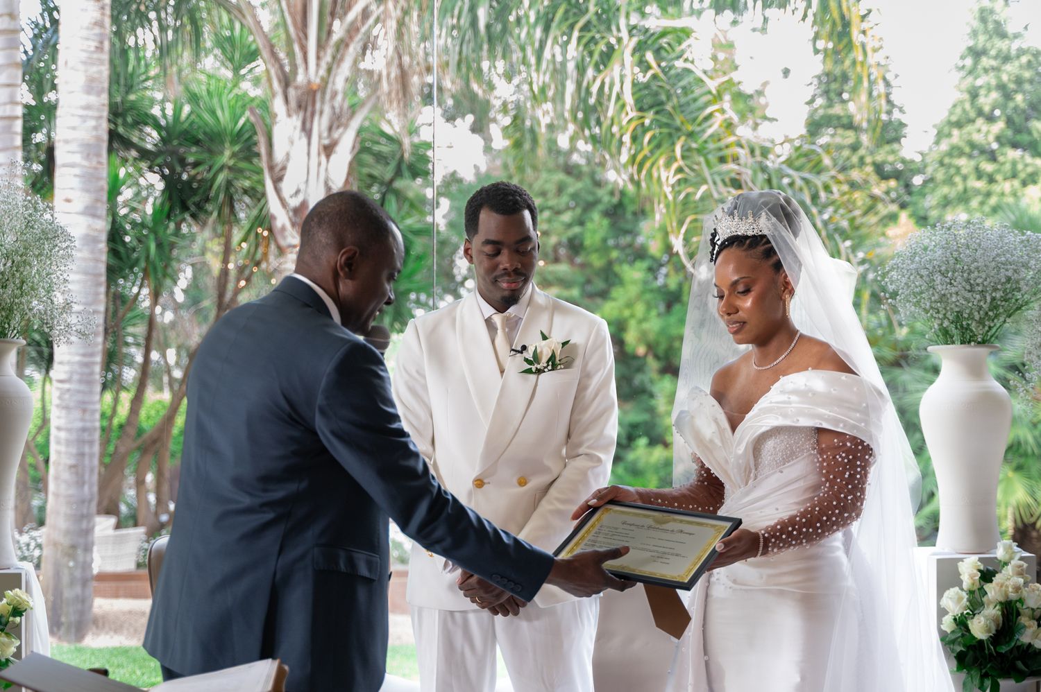 Bride and groom exchanging vows with officiant at outdoor wedding ceremony.