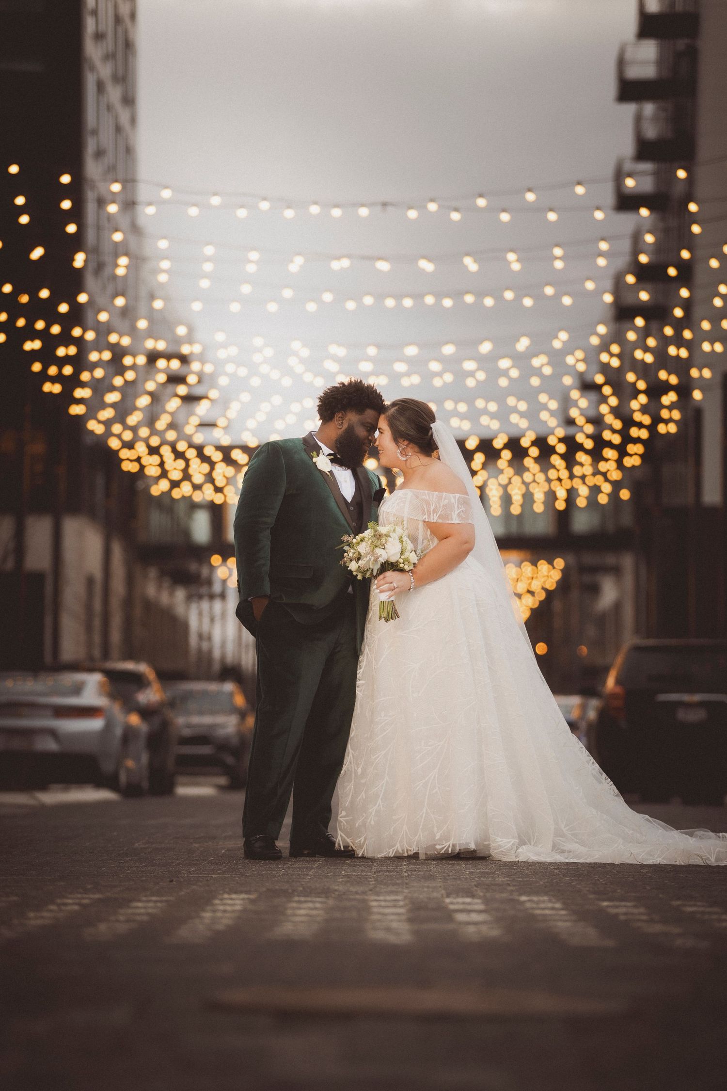 Romantic evening wedding scene with string lights creating magical ambiance.
