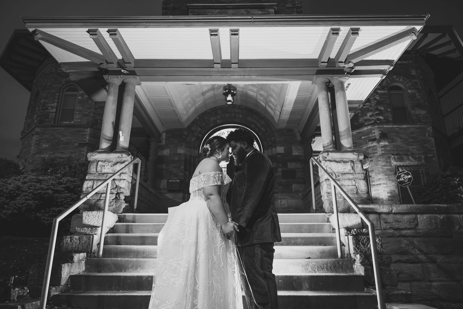 Series of black and white wedding photos showing a couple descending stone stairs.