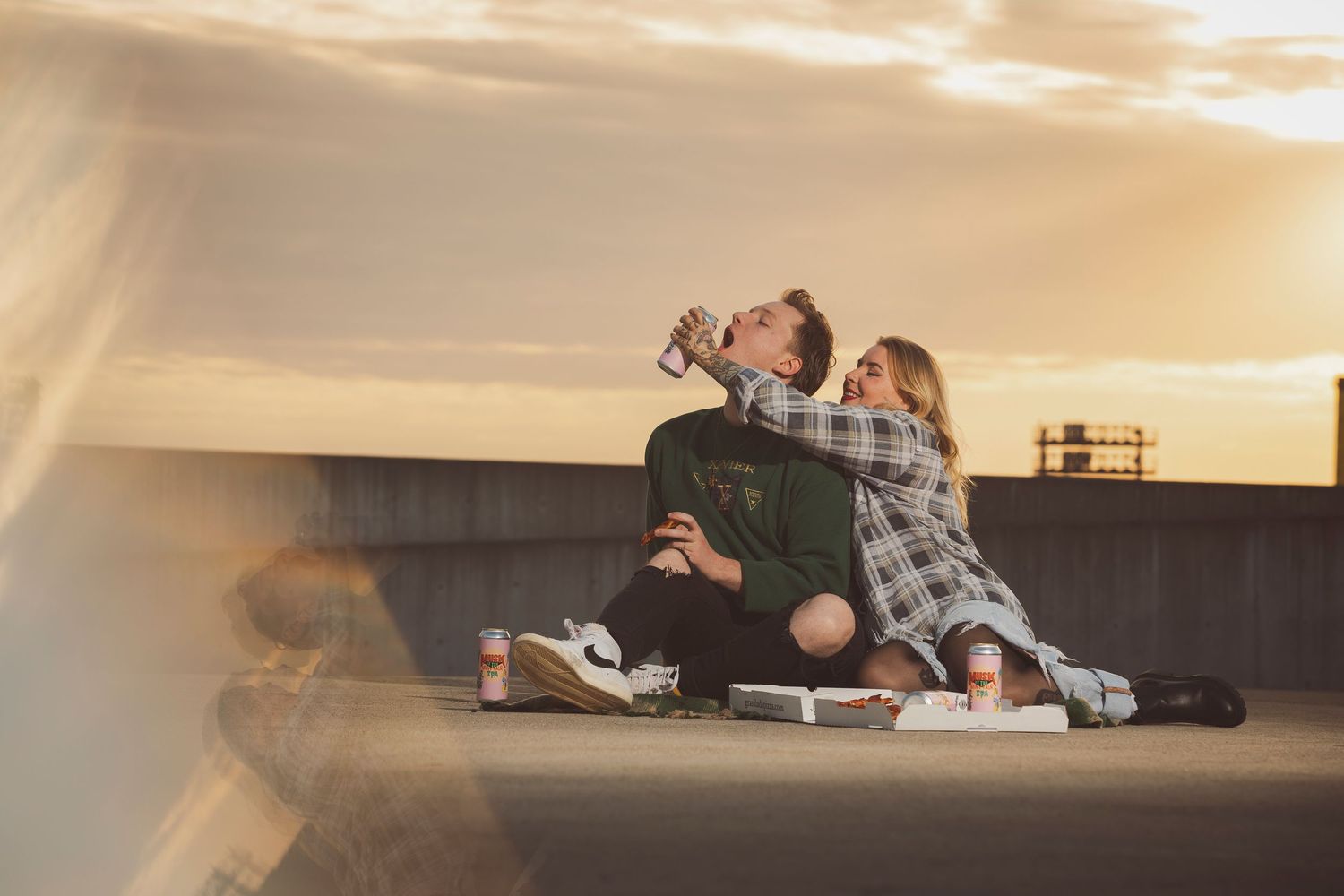 Couple shares intimate moments during a rooftop sunset date.