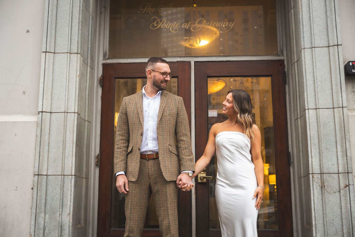 Stone architectural entrance with classic details framing a formal occasion.