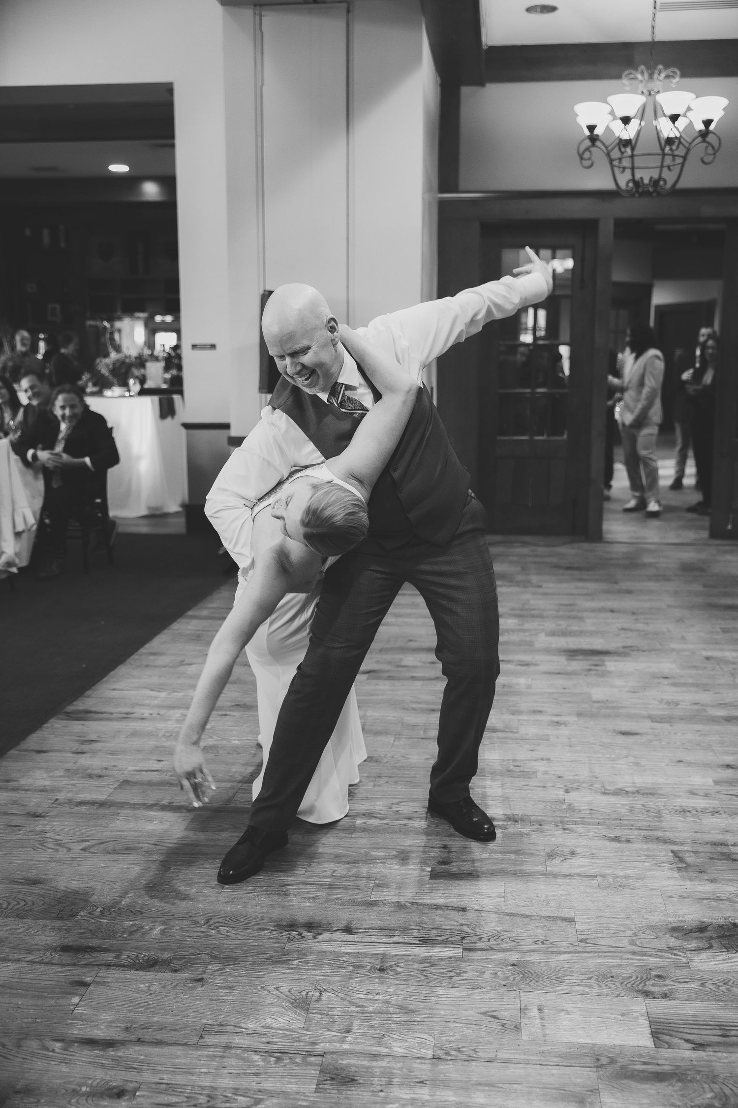 Black and white photo sequence of dancing couple performing dramatic dip on wooden floor.