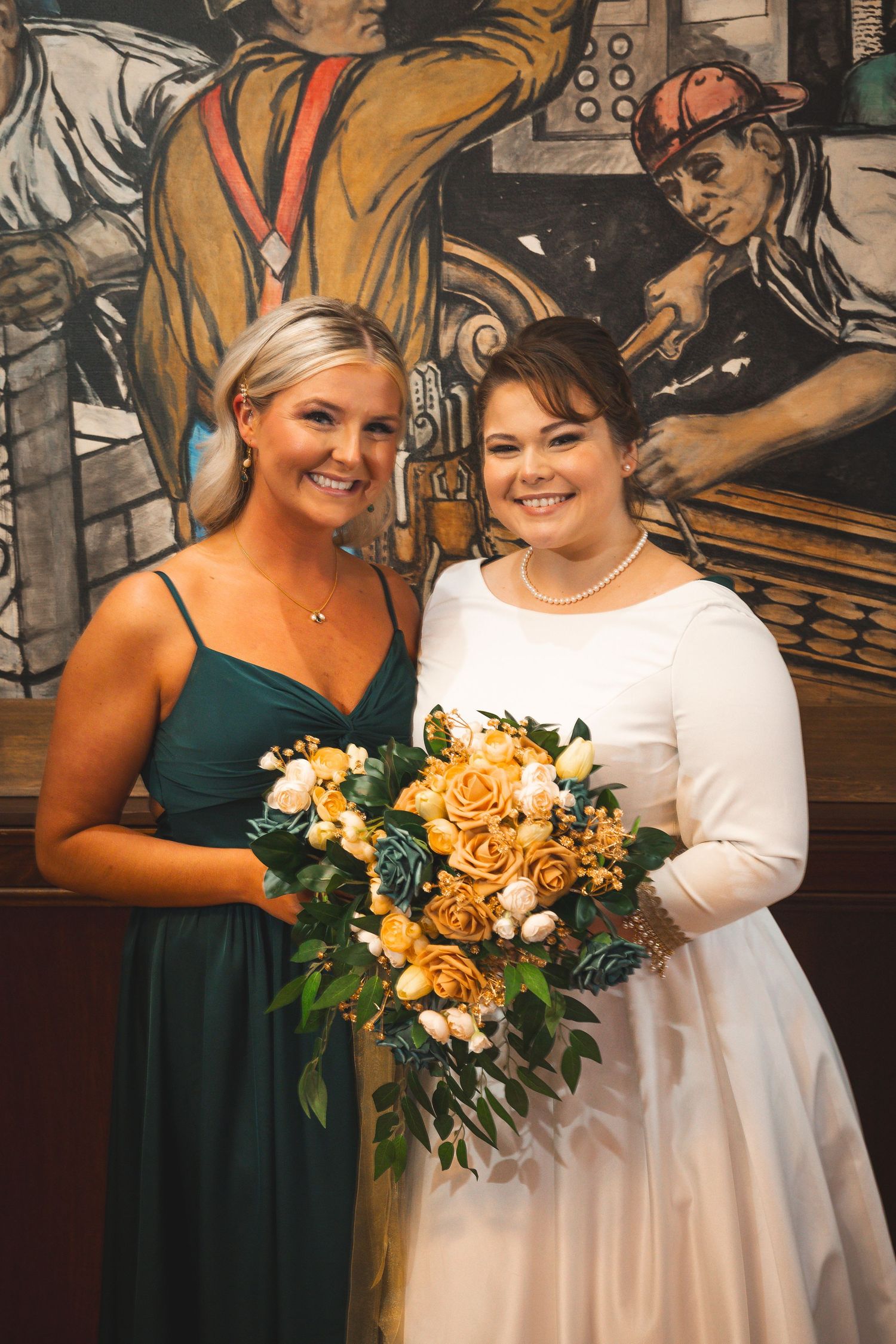 Wedding bouquets featuring golden yellow roses and dark teal accents.