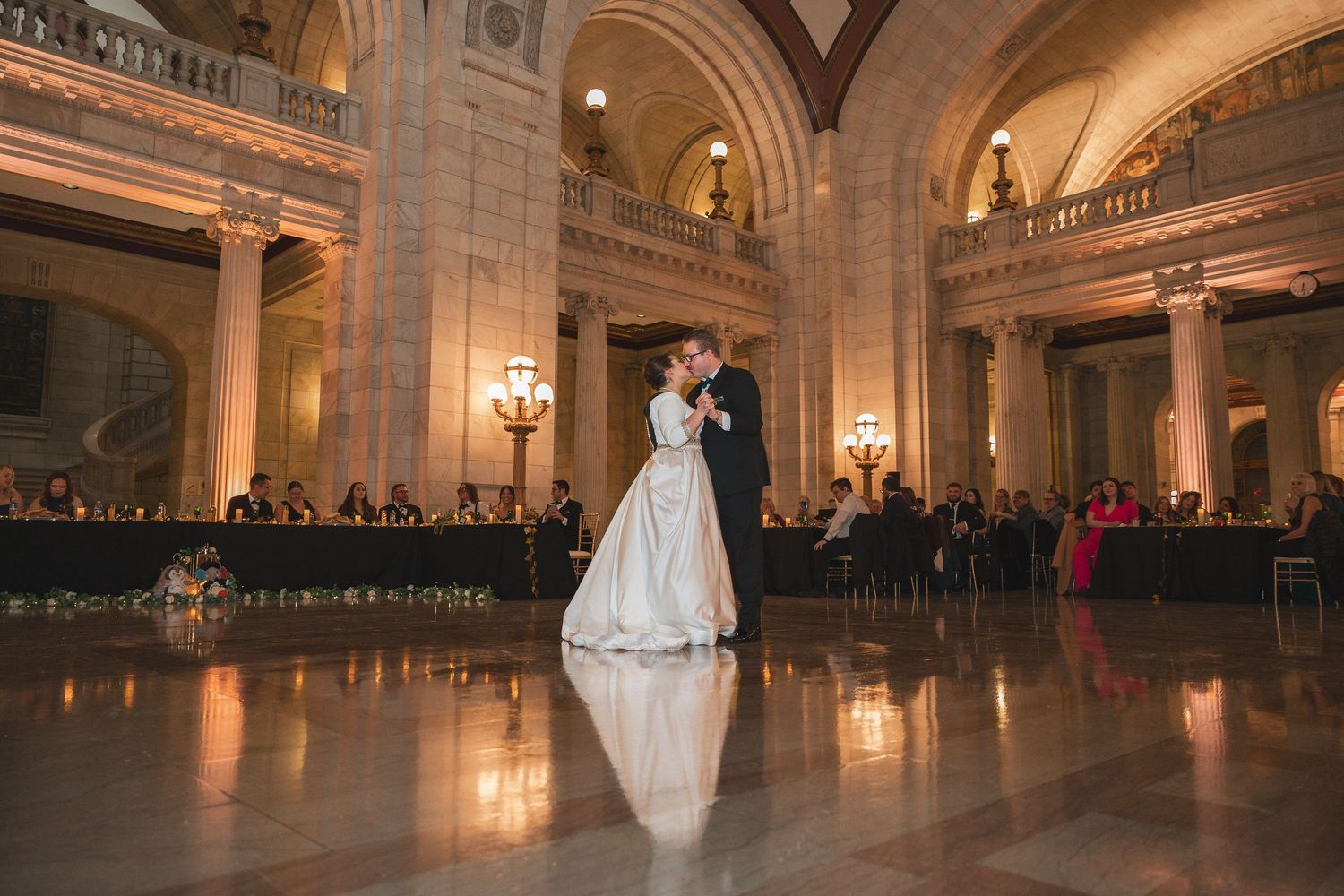 Elegant grand ballroom with ornate architecture and warm lighting creates a romantic atmosphere for special events.