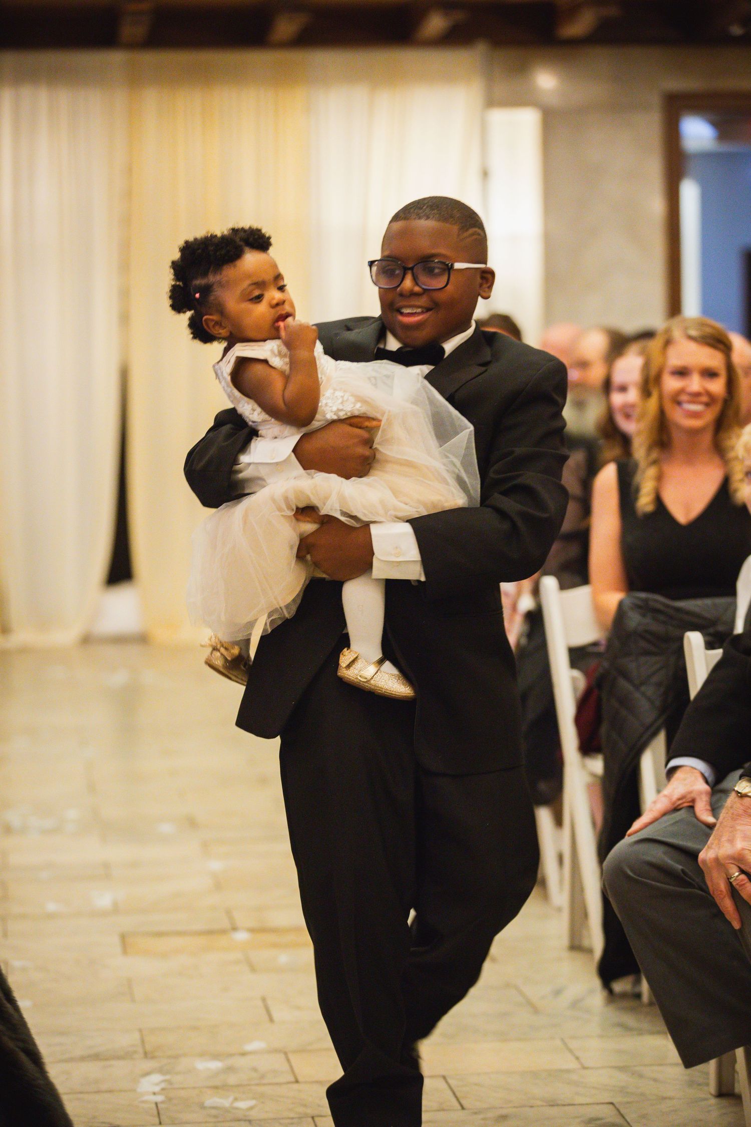 Wedding celebration featuring lively dancing and joyful moments on a stone floor.