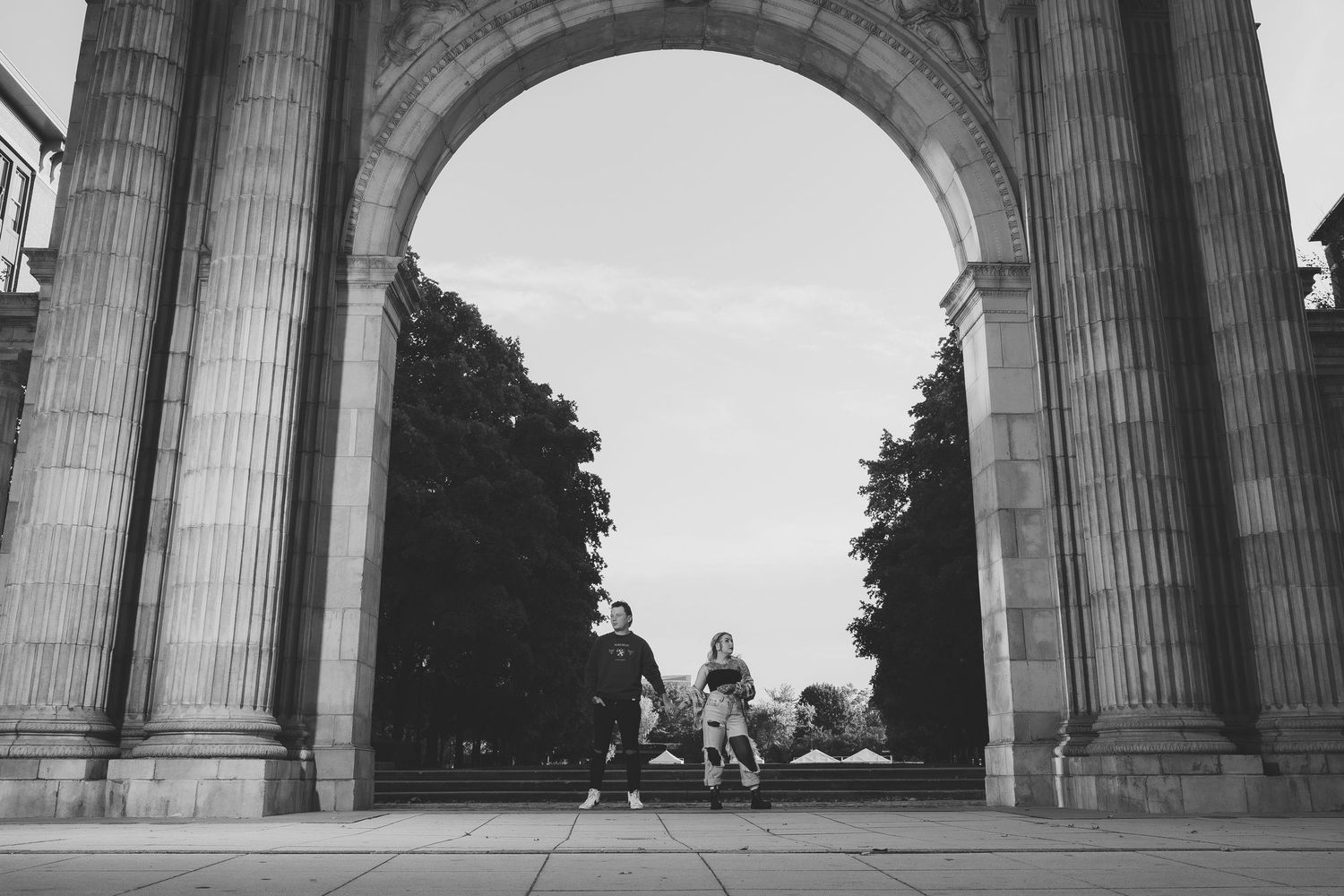 Black and white architectural photo of classical stone columns and arches.