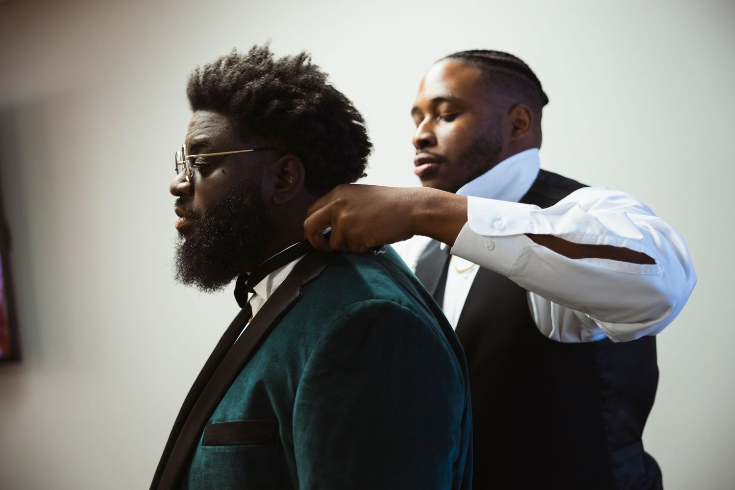 Side profile shots of groomsmen in formal attire against a white background.