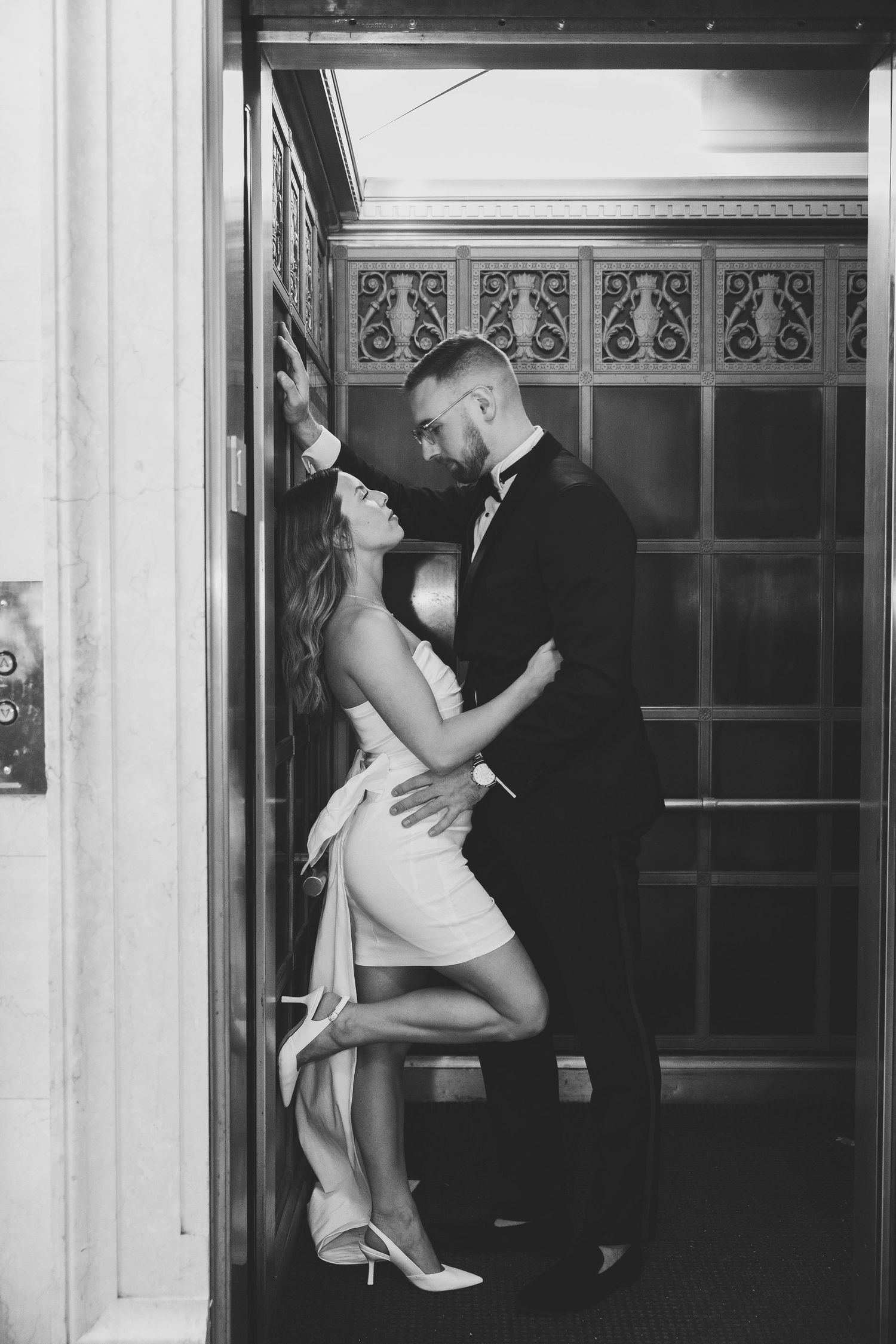 Black and white sequence of an intimate dance moment in an elegant doorway.